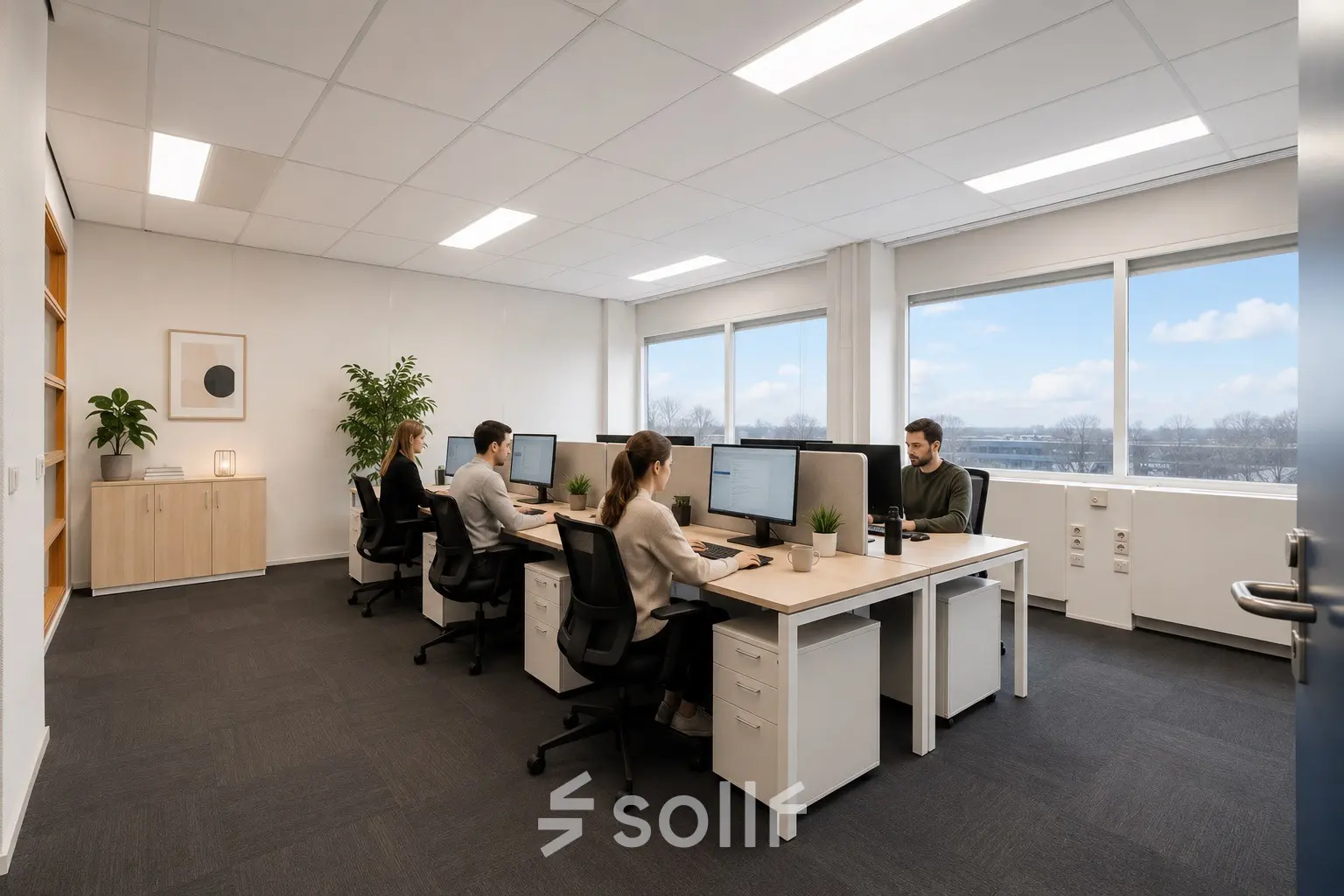 Office space rental with professionals working on computers at A. Hofmanweg 5A, Haarlem Waarderpolder. Bright windows with natural light illuminate the modern workspace.