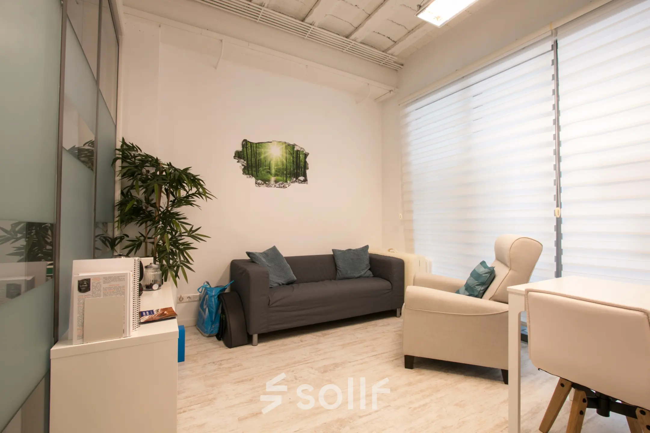 Bright office space rental at Waarderweg 19, Haarlem Waarderpolder, featuring a cozy seating area with a sofa and armchair. Ideal for those looking to rent office space with natural light.