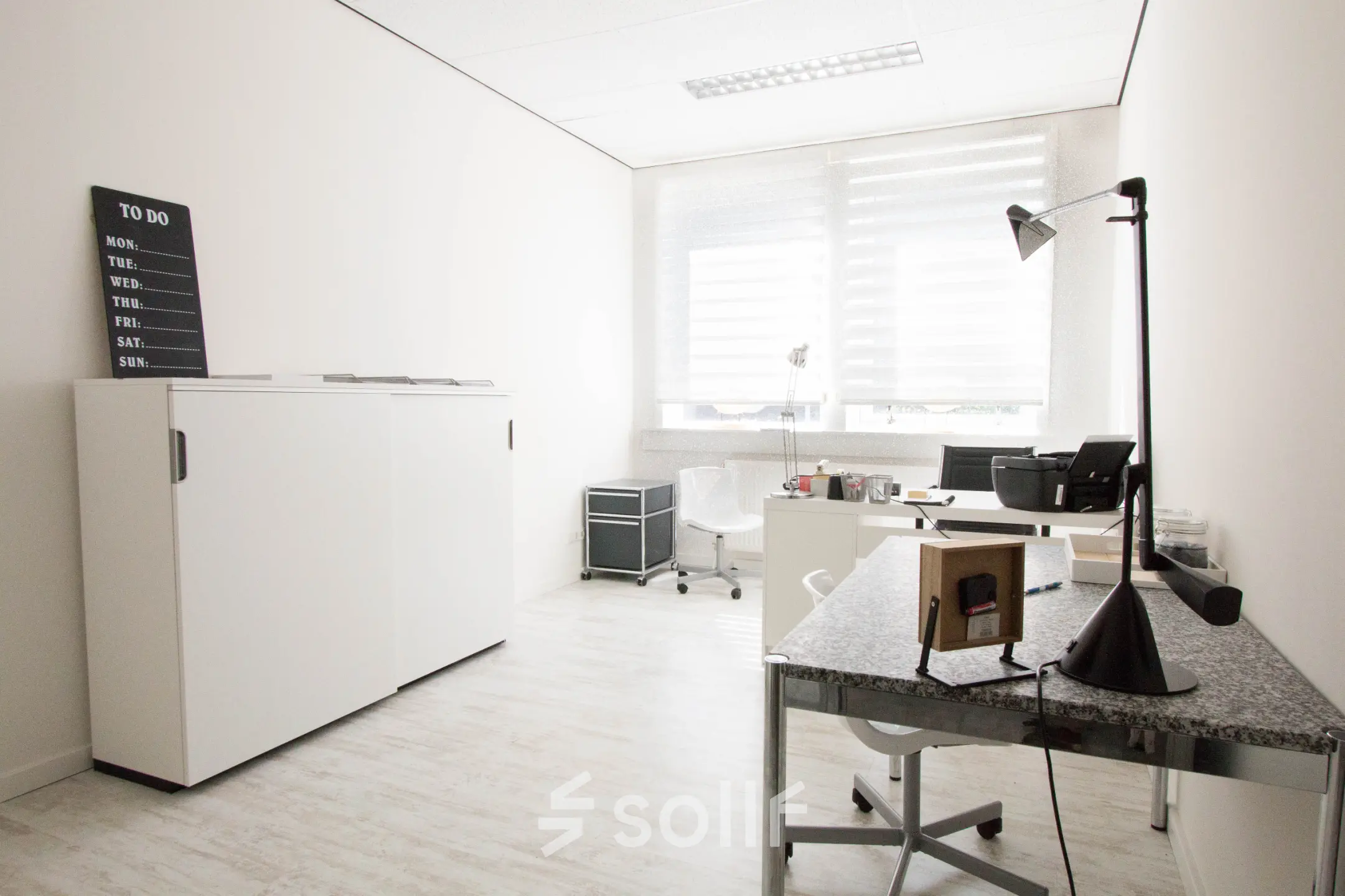 Bright office space at Waarderweg 19 in Haarlem Waarderpolder, with modern furnishings including a desk, chair, lamp, and cabinet, available for office space rental.