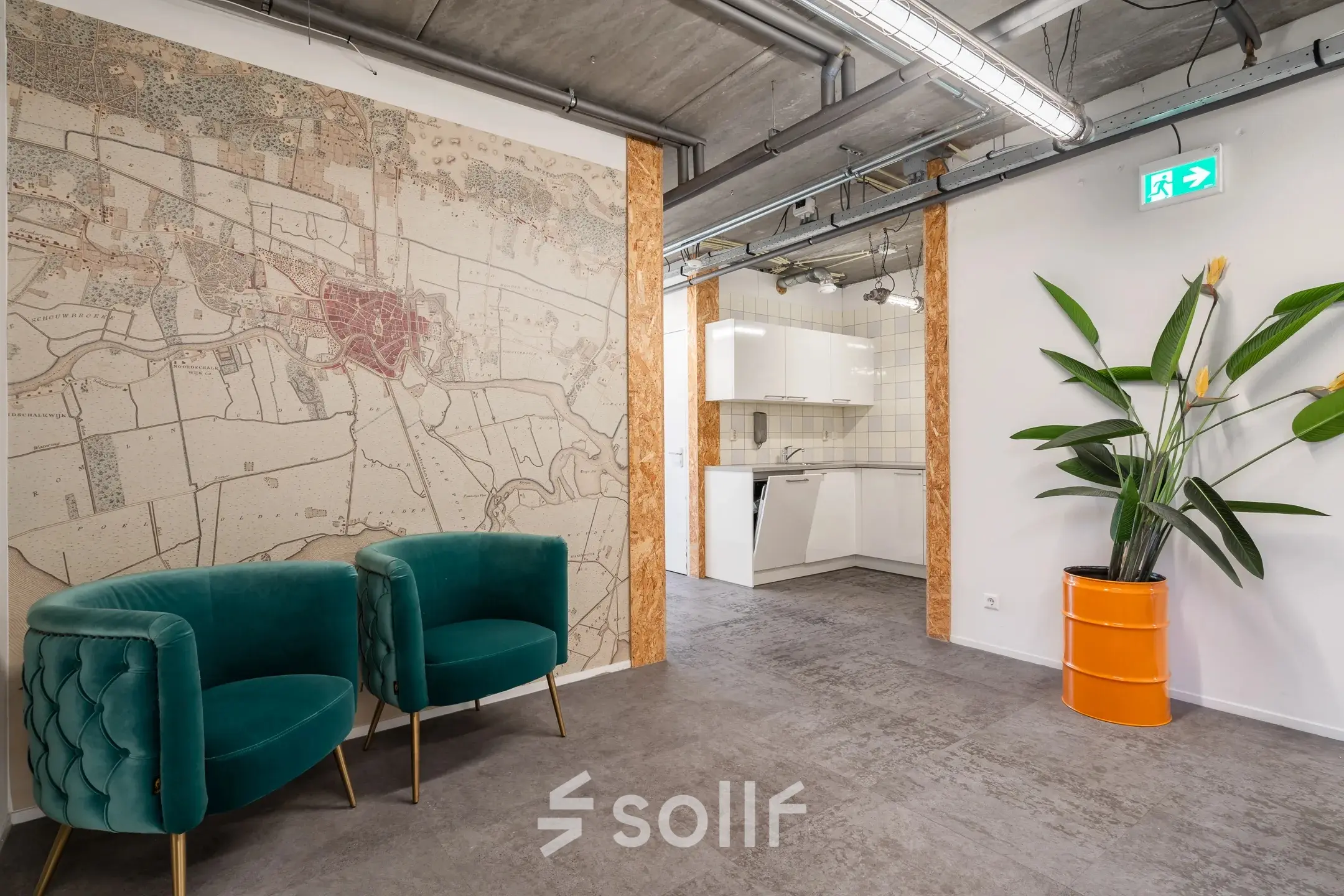 Office interior at Waarderweg 52 in Haarlem Waarderpolder, featuring a map mural, green chairs, and a kitchenette. Ideal for office space rental.