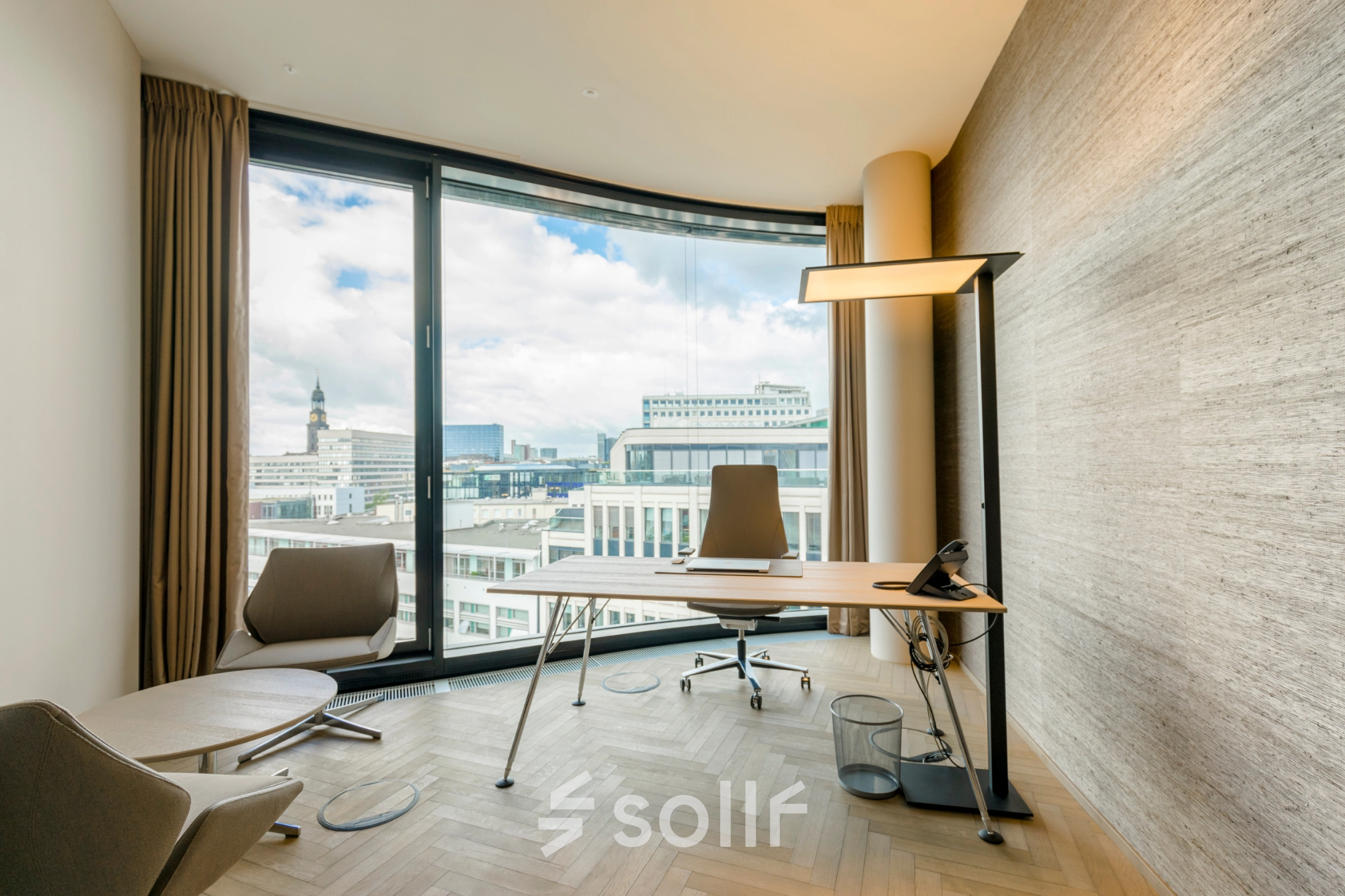 Modern office space with a desk, two chairs, and a panoramic window view in Hamburg Neustadt, perfect for office space rental.