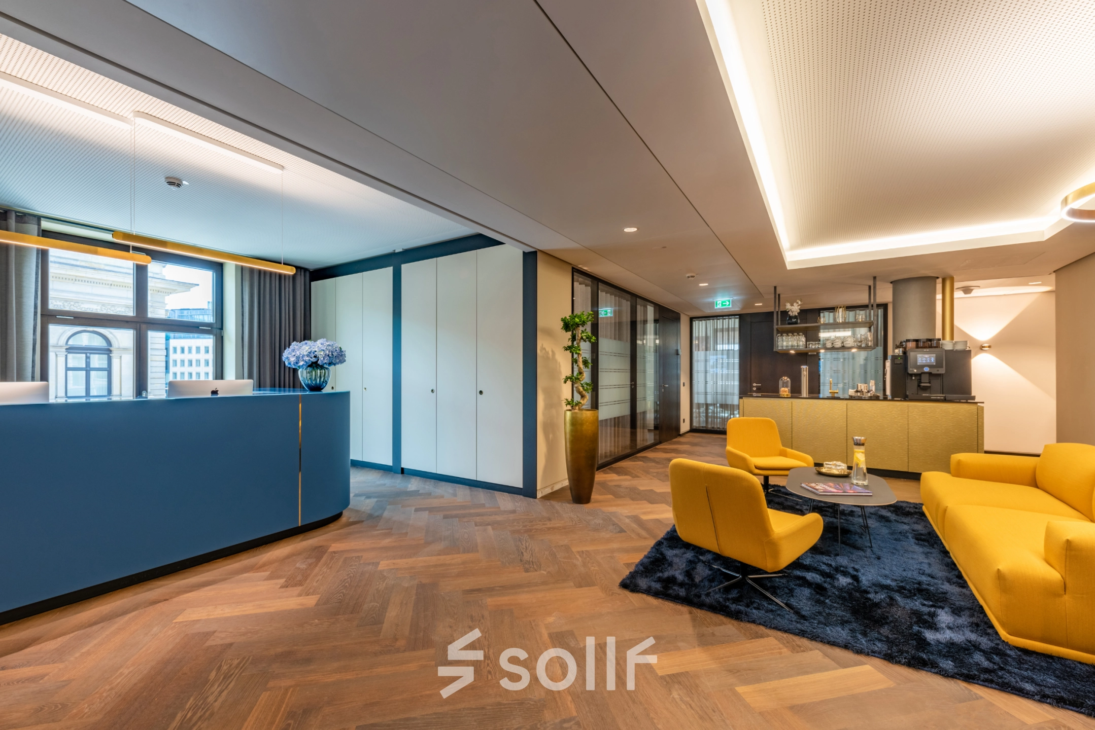 Bright reception area at Alter Wall 32, Hamburg Old Town. Features sleek decor and vibrant seating, ideal for office space rental.