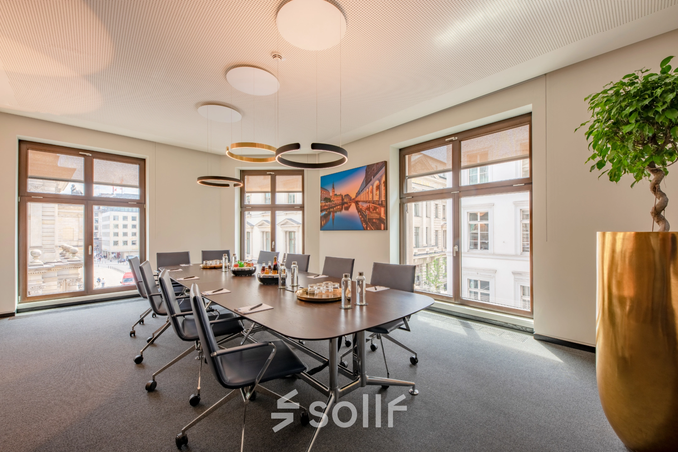 Bright conference room at Alter Wall 32, Hamburg Old Town with a large table and modern chairs, suitable for anyone looking to rent office space.