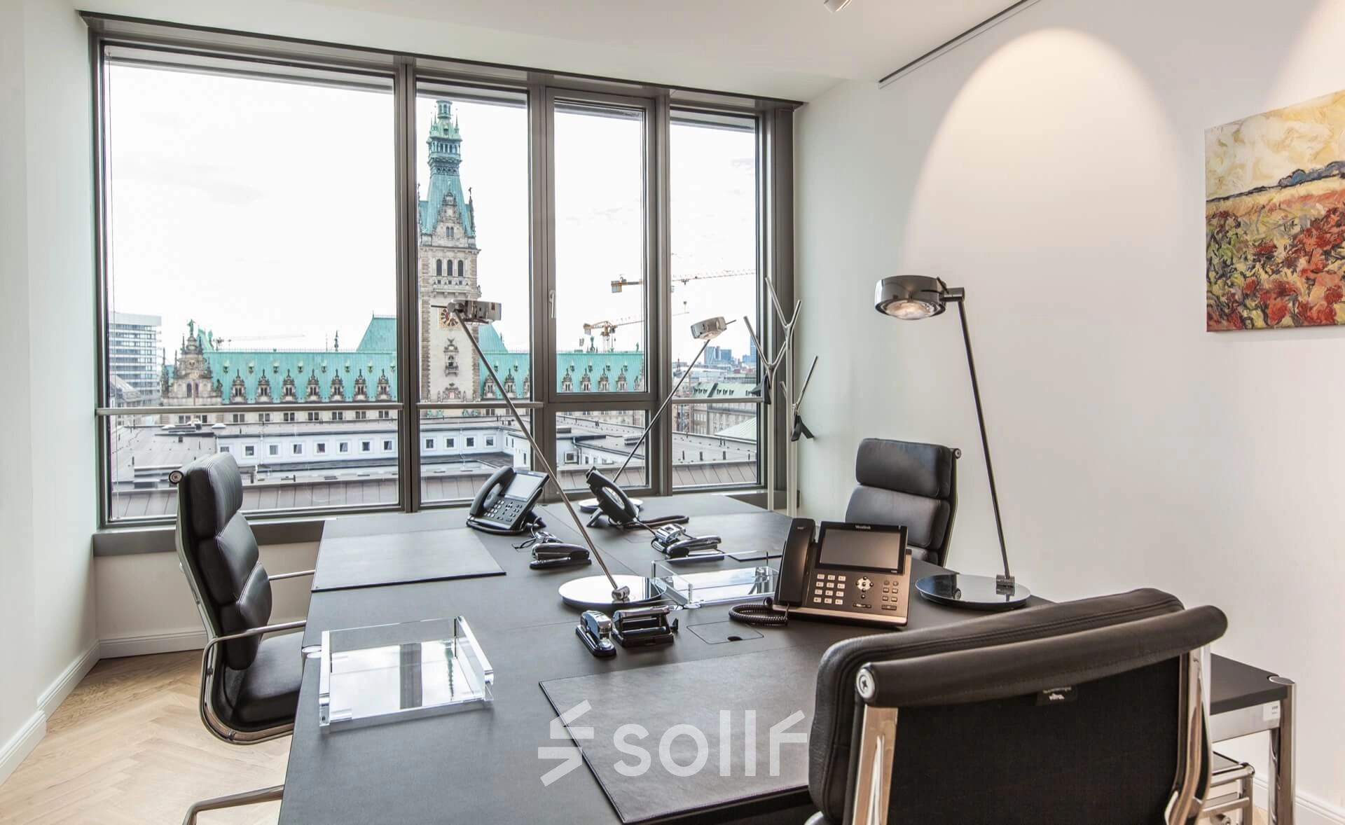 Modern furnished office space rental at Ballindamm 39 in Hamburg Old Town, featuring large windows with a city view and professional desks.