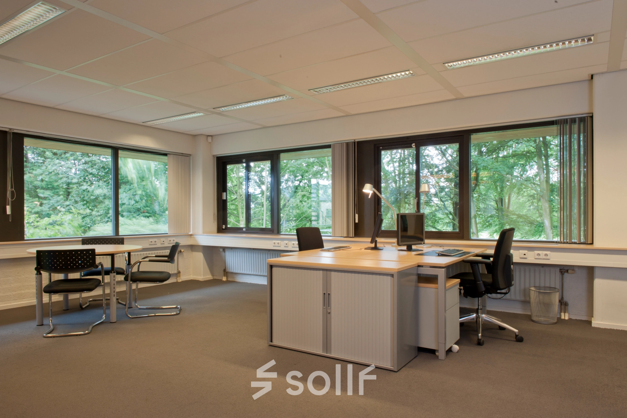 Furnished office space at Herenweg 115, Heemstede with desks and chairs near large windows, ideal for rent office space.