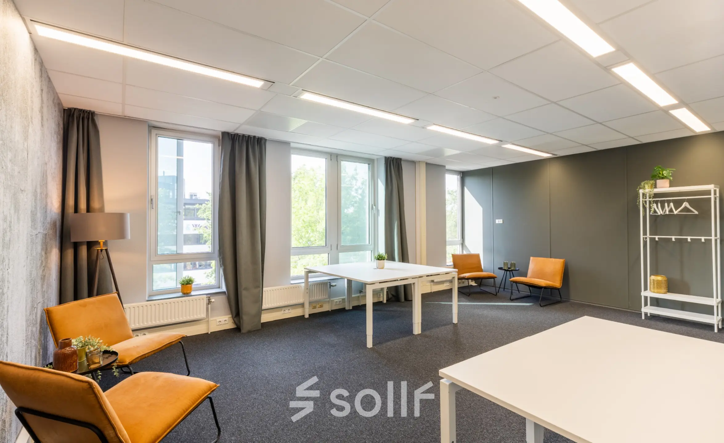 Bright office space to rent at Demmersweg 3 in Hengelo with modern furnishings, including desks and chairs, suitable for collaborative work.