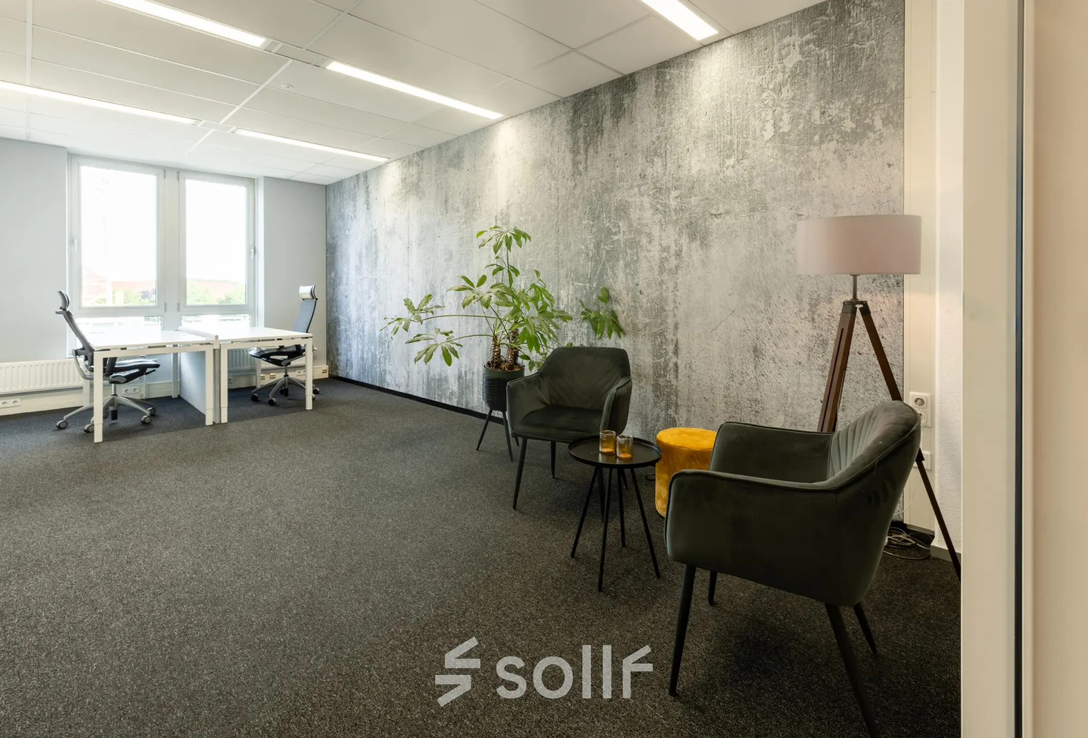 Modern office space at Demmersweg 3, Hengelo, featuring furnished seating area and work desks, ideal for office space rental.
