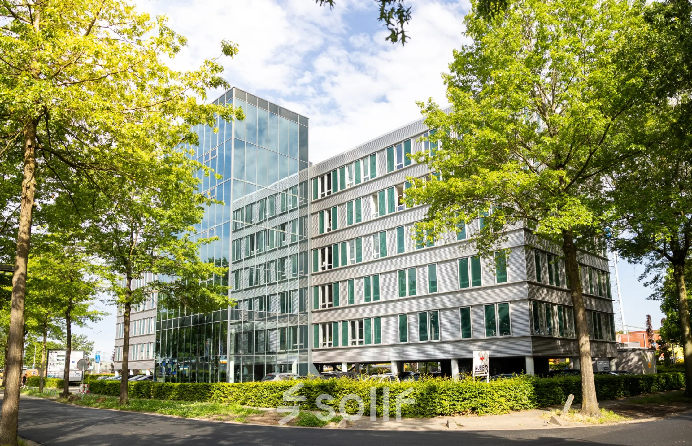 Exterior view of the Hengelo office building at Demmersweg 3, showcasing its modern architecture and surrounding greenery.