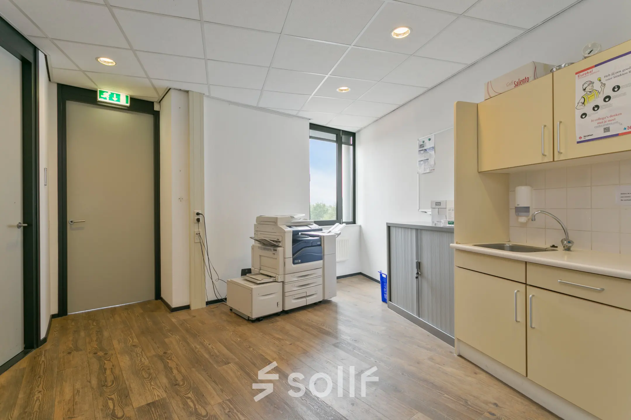 Interior view of an office space at Welbergweg 60, Hengelo, featuring a printer and a small kitchenette. Ideal for office space rental.