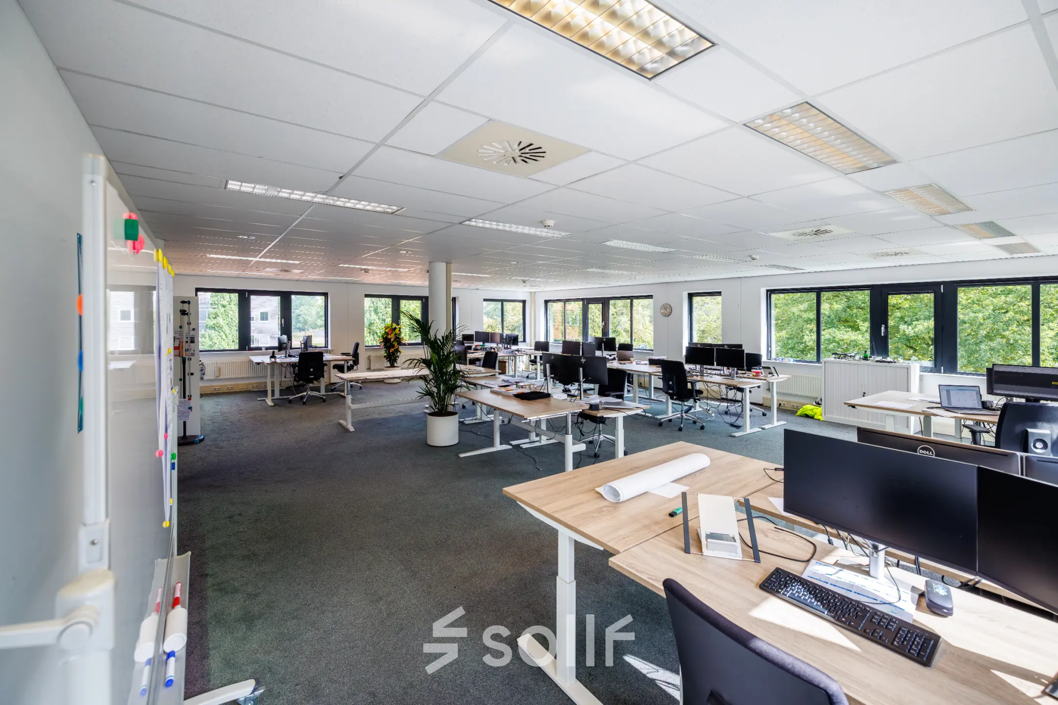 Spacious office to rent at Welbergweg 60, Hengelo, featuring bright workstations with modern furnishings and large windows for natural light. Ideal for office space rental seekers.