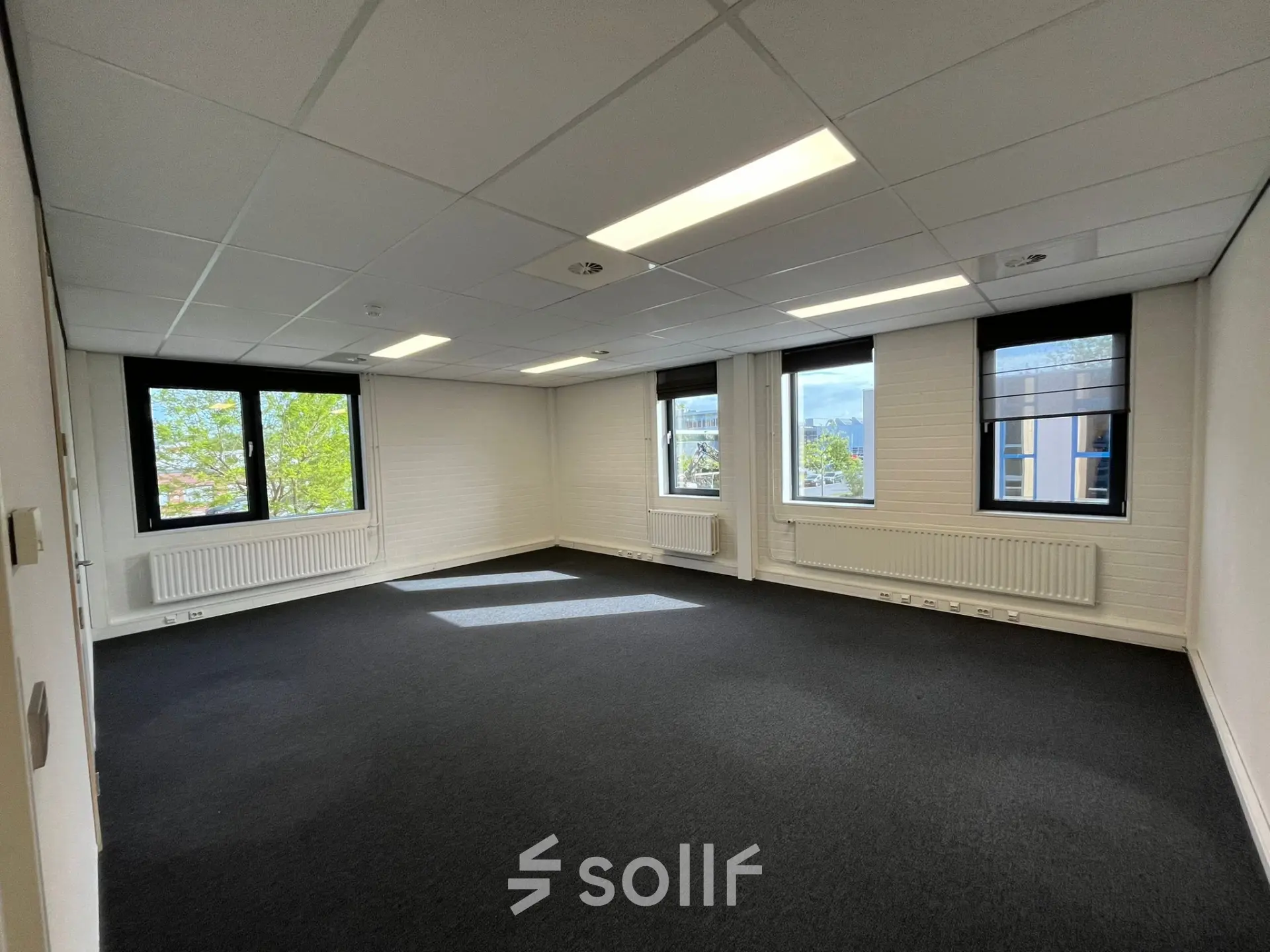 Bright, unfurnished office space available for rent at Catharina van Renneslaan 8-10 in Hilversum, featuring large windows and a clean, professional interior.