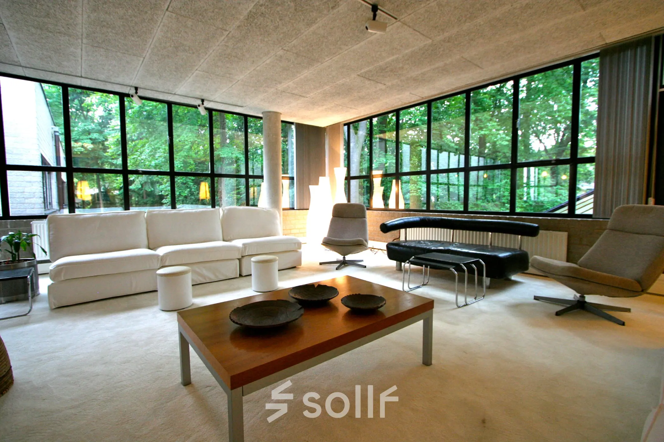 Bright office space with modern furnishings, large windows providing natural light at Catharina van Renneslaan 8-10, Hilversum. Ideal for office space rental.