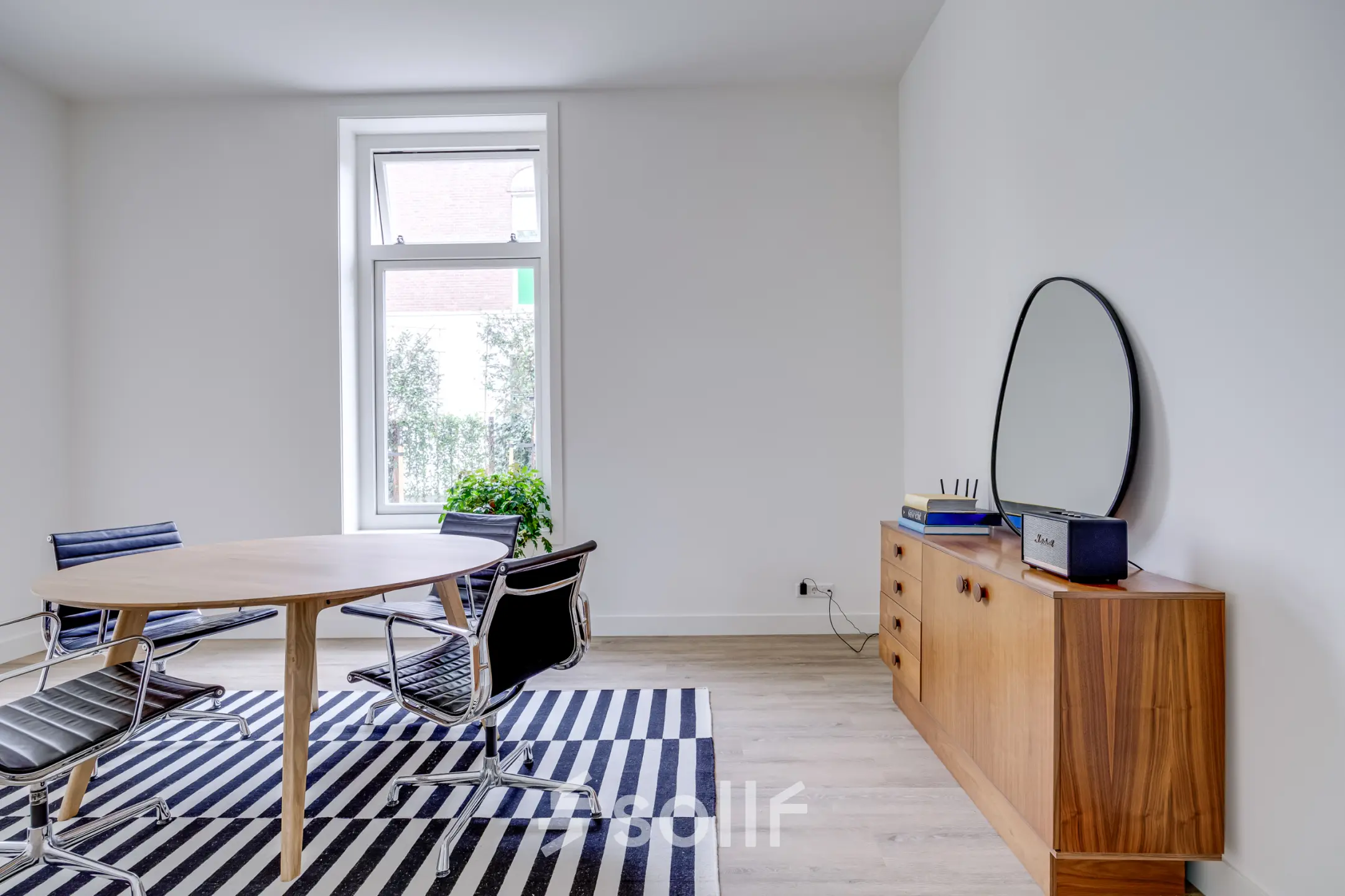 Office space rental at Graaf Florislaan 40, Hilversum, featuring a modern room with a table, chairs, and a cabinet.