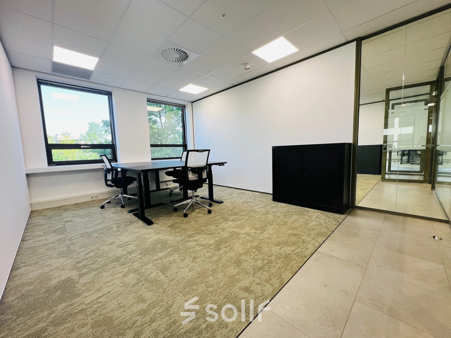 A bright office to rent at Marathon 2, Hilversum, featuring desks, chairs, and ample natural light. Ideal for office space rental needs.