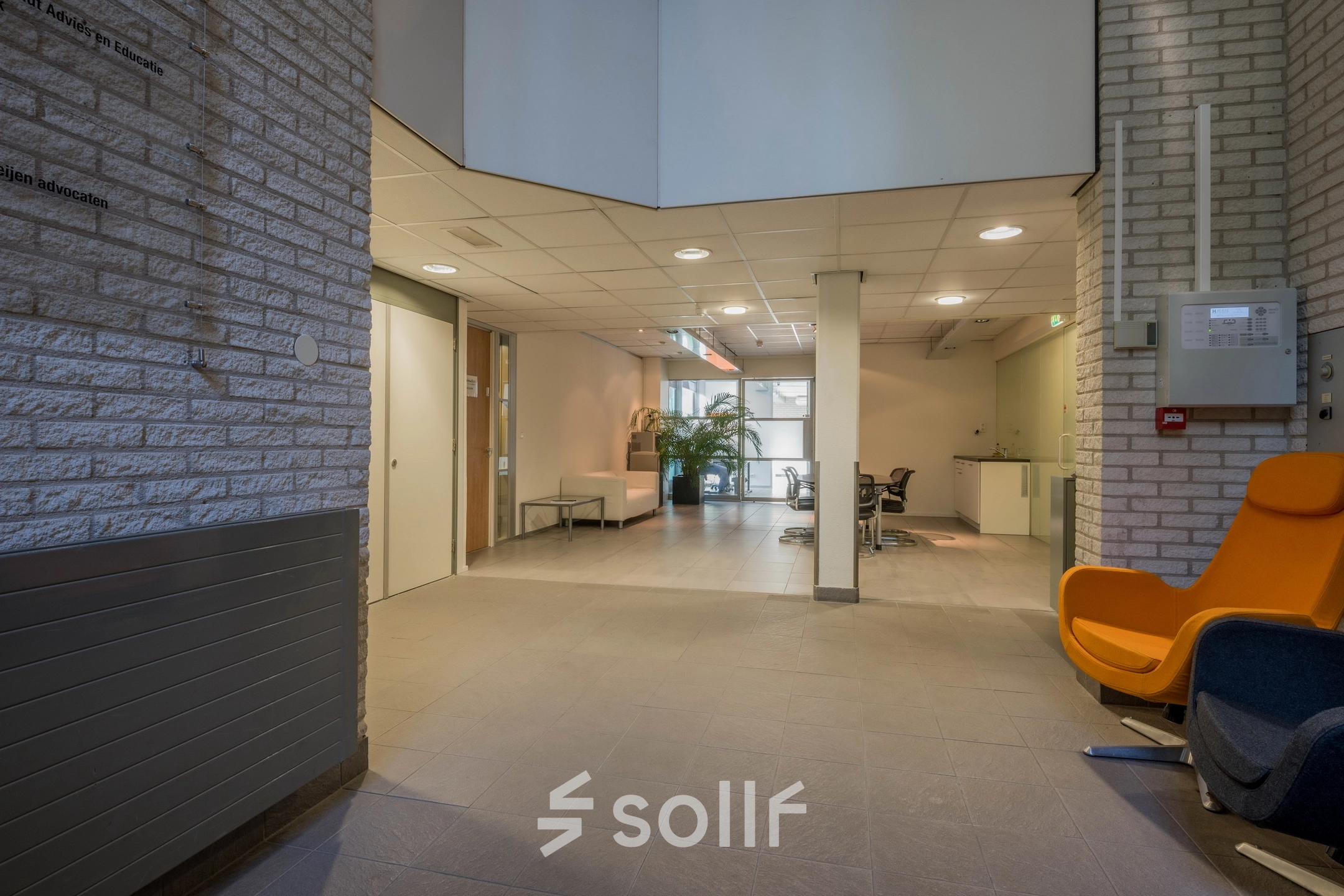 Spacious office area at Mozartlaan 27 in Hilversum, ideal for office space rental with a few workstations, bright lighting, and modern seating.