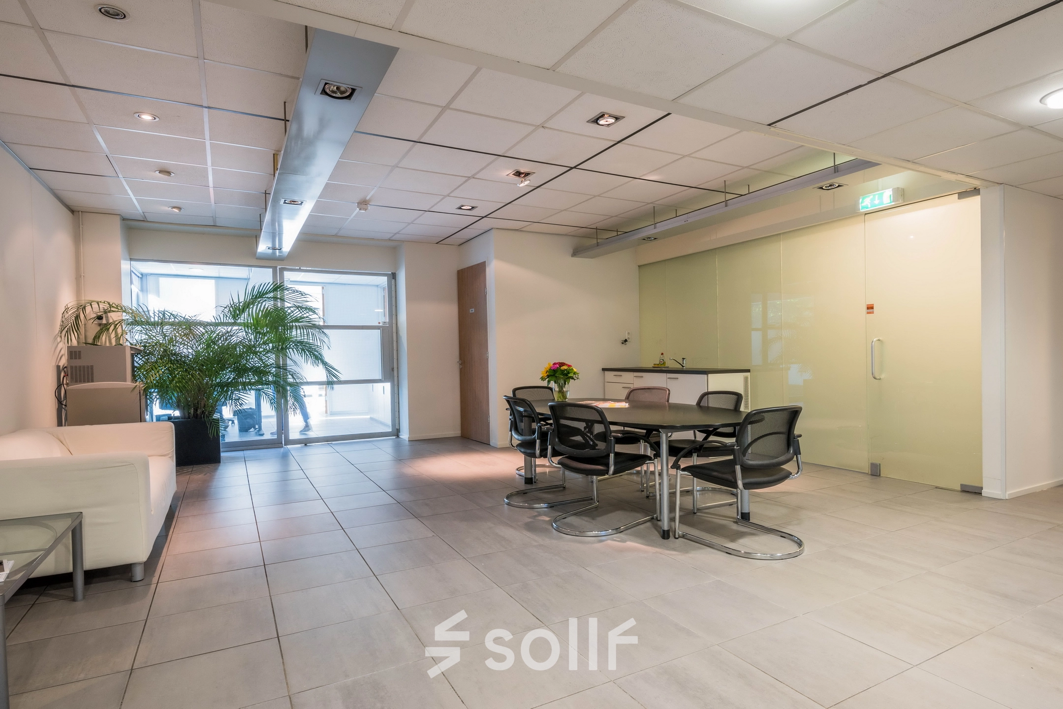 Bright office space at Mozartlaan 27, Hilversum, with modern furnishings and a meeting table. Ideal for office space rental.