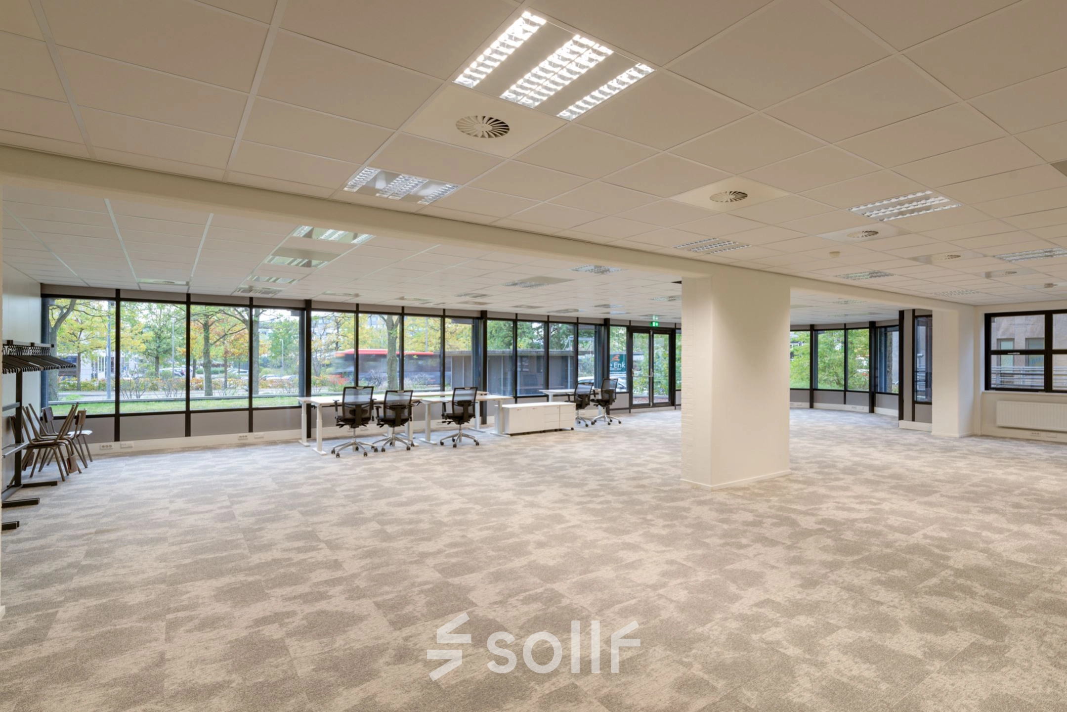 Interior view of an unfurnished office space for rent at Olympia 1, Hilversum, featuring large windows and ample floor area ideal for customization.