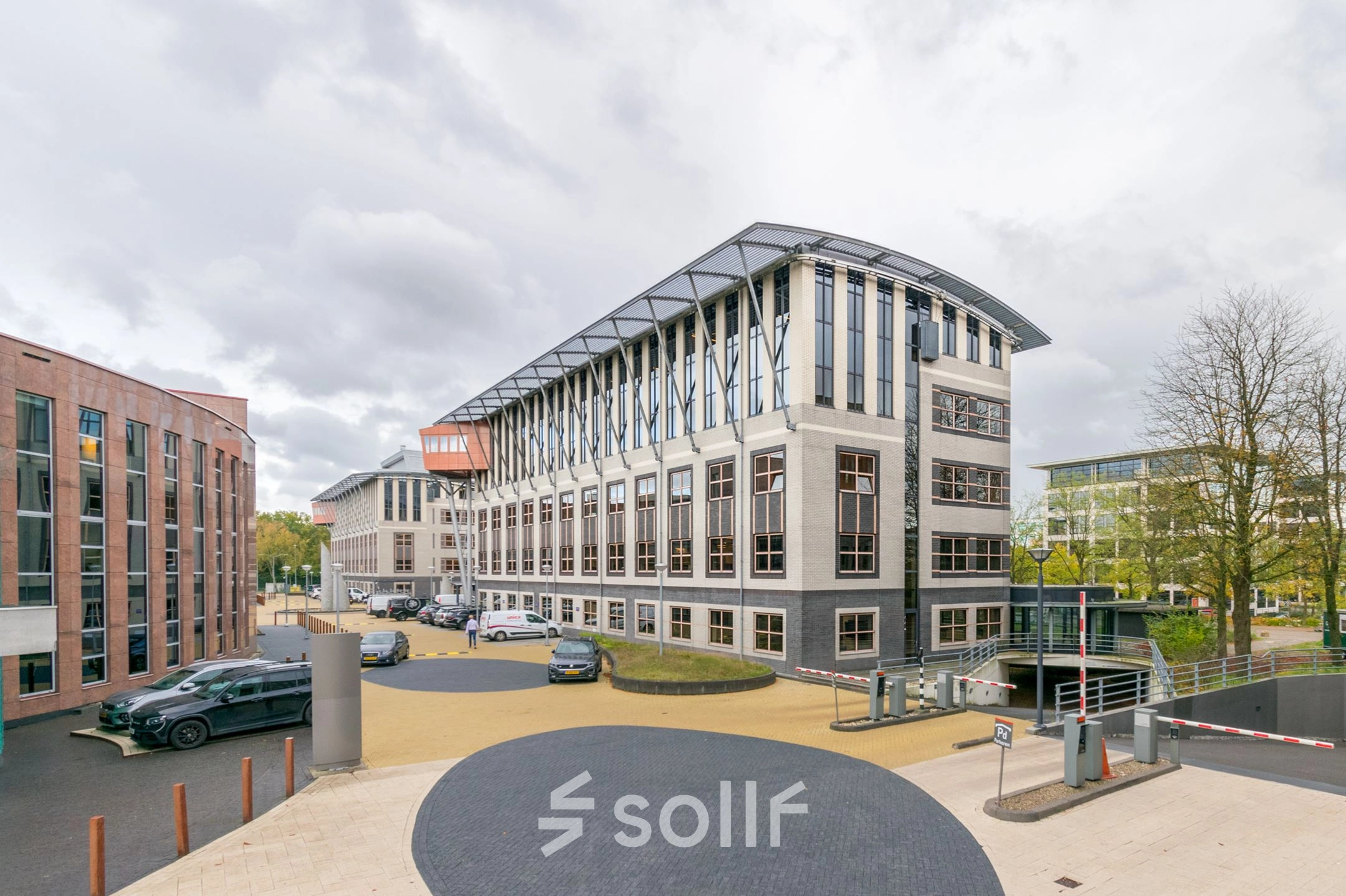 Exterior view of Olympia 1 in Hilversum, showcasing a modern office building available for rent.