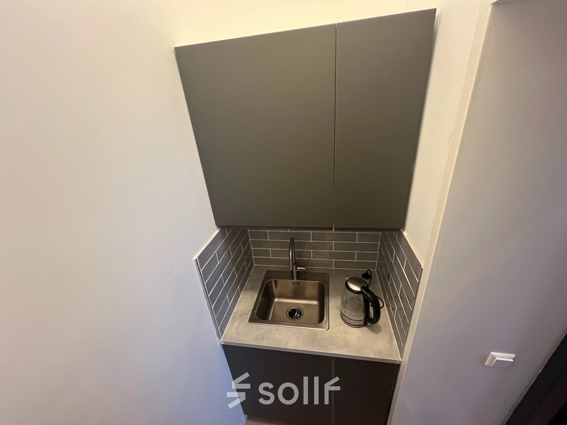 Compact kitchenette with a sink and kettle located in an office space rental at Oude Enghweg 8, Hilversum.