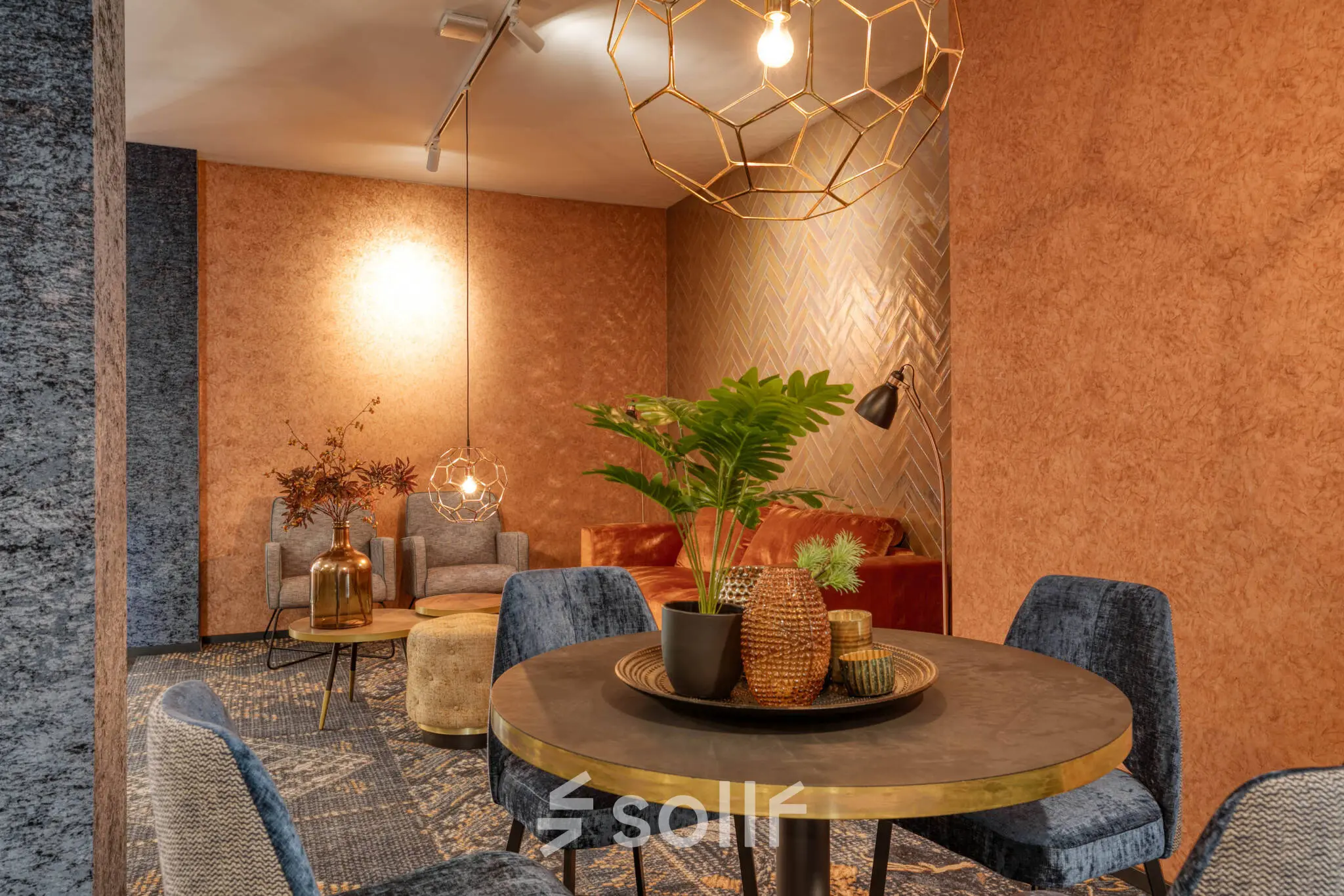 Cozy furnished office space for rent at Steijnlaan 16, Hilversum, featuring stylish seating and warm decor.