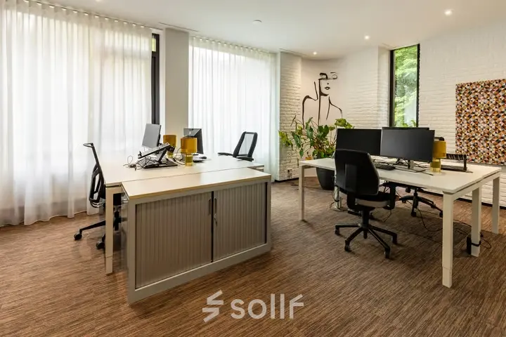 Modern office space with desks, chairs, and computers, available to rent at Steijnlaan 16, Hilversum. Bright interior with large windows and contemporary decor for productive workspaces.
