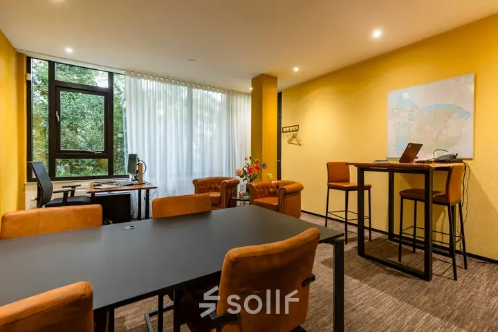 A bright and inviting office space with a meeting table, chairs, and a map on the wall at Steijnlaan 16, Hilversum. Ideal for office space rental.