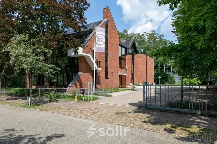 Exterior view of an office building at Steijnlaan 16, Hilversum, showcasing a modern brick design. Ideal for office space rental.
