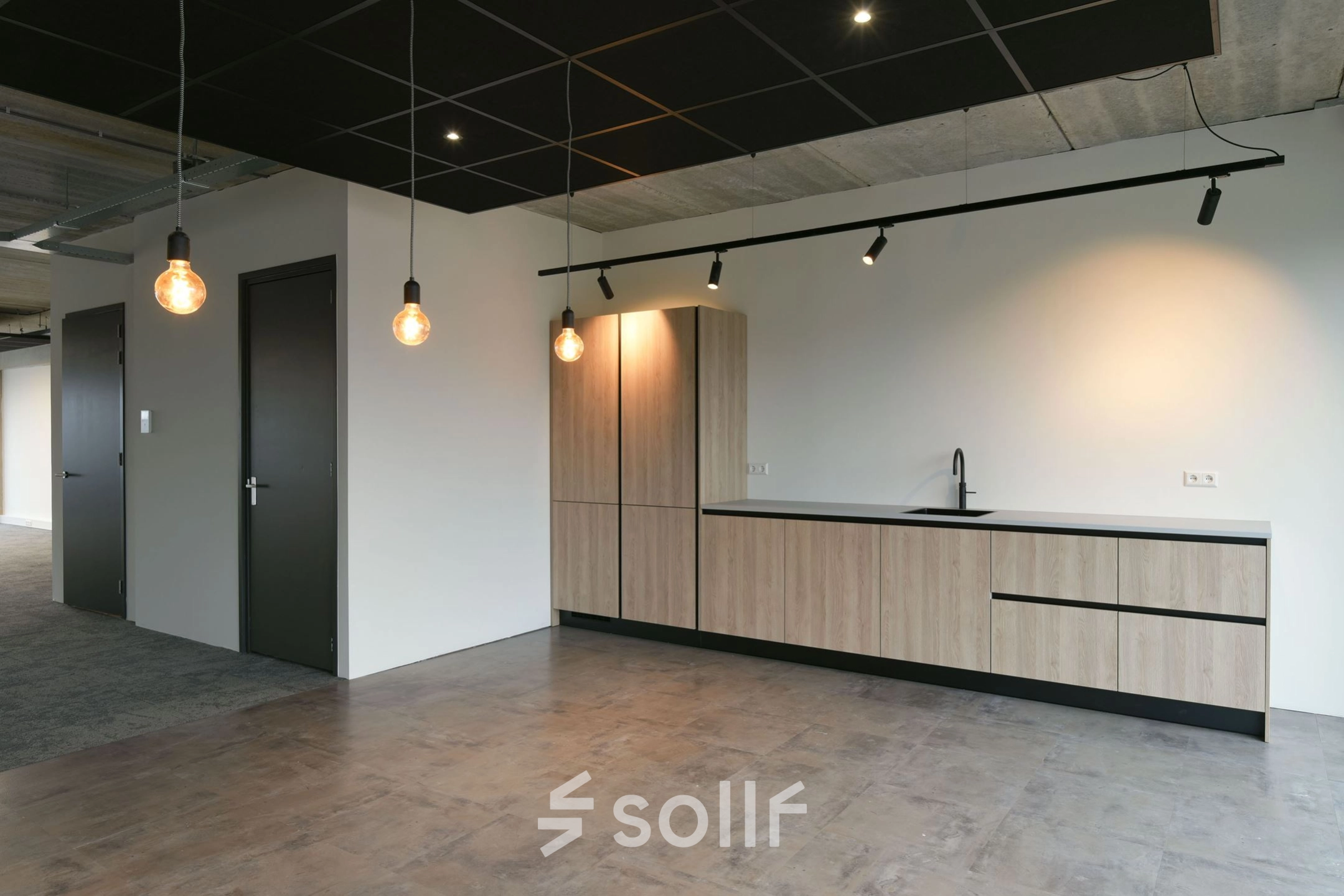Modern office space with sleek lighting and minimalistic design available for rent at Zuiderloswal 55, Hilversum.