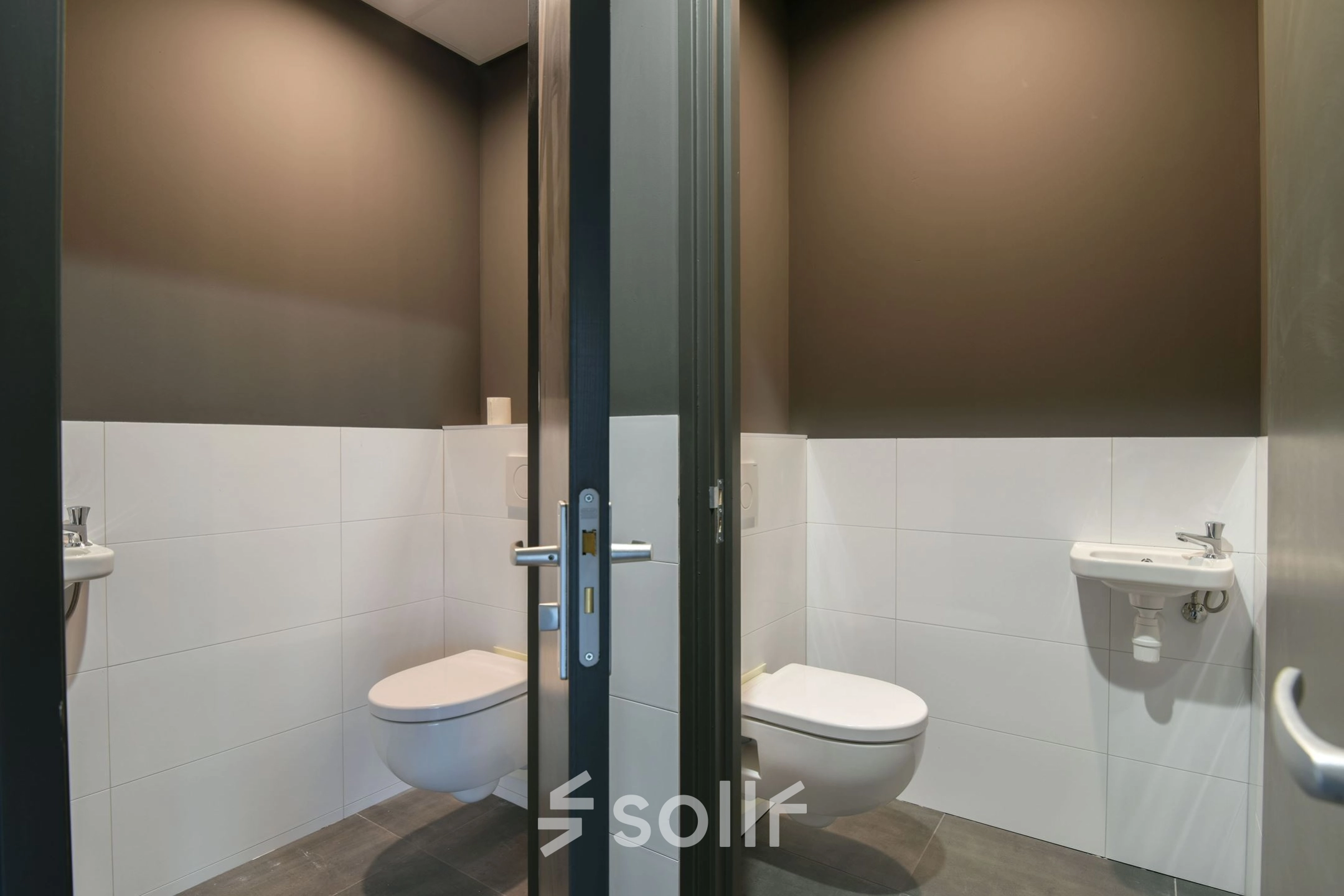 Compact restroom at office space rental on Zuiderloswal 55, Hilversum, featuring minimalist design and modern fixtures.