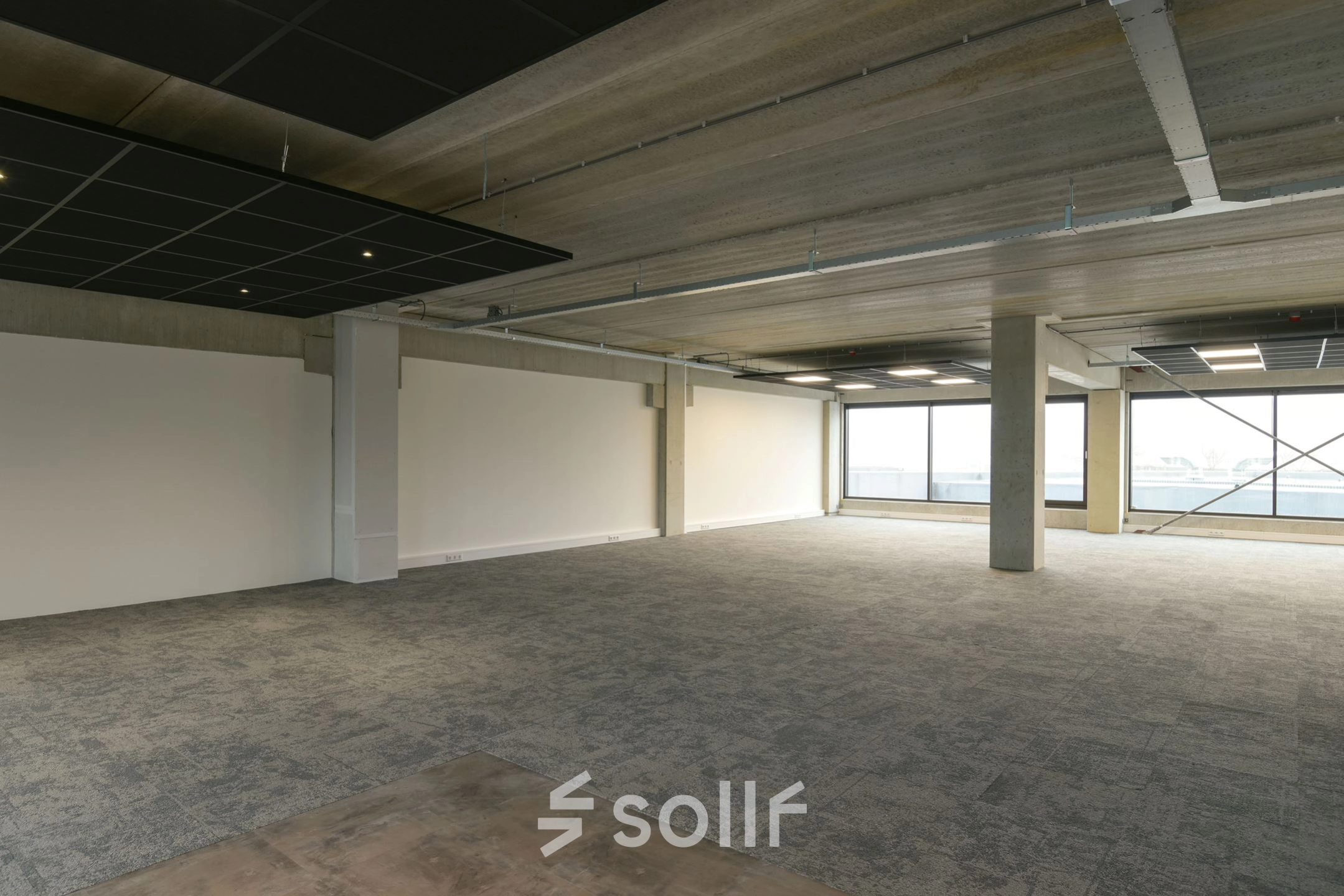 Spacious office area at Zuiderloswal 55, Hilversum, available for rent with large windows allowing natural light, ideal for office space rental.