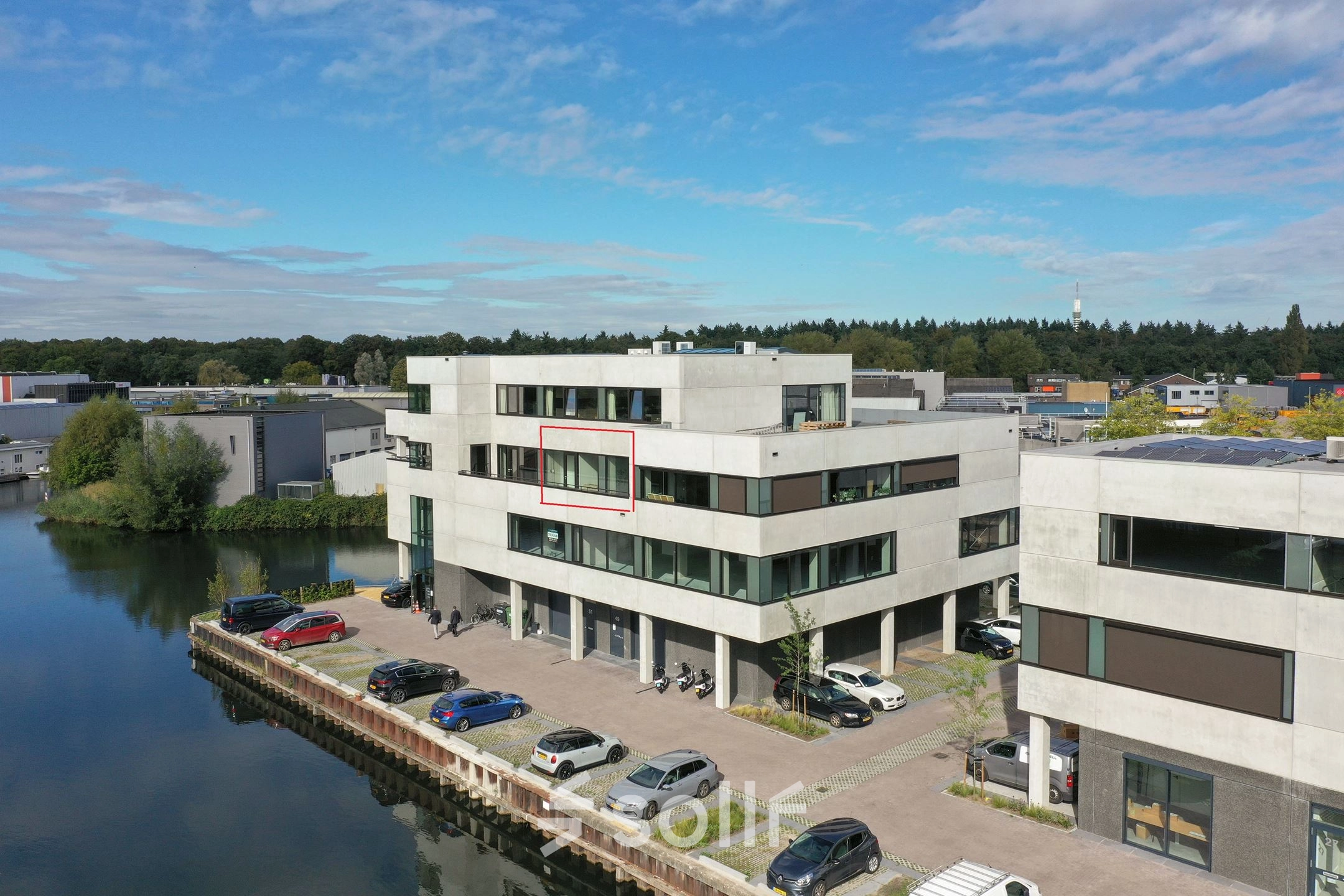 Exterior view of an office building at Zuiderloswal 55, Hilversum, showcasing potential office space rental opportunities by the waterfront.