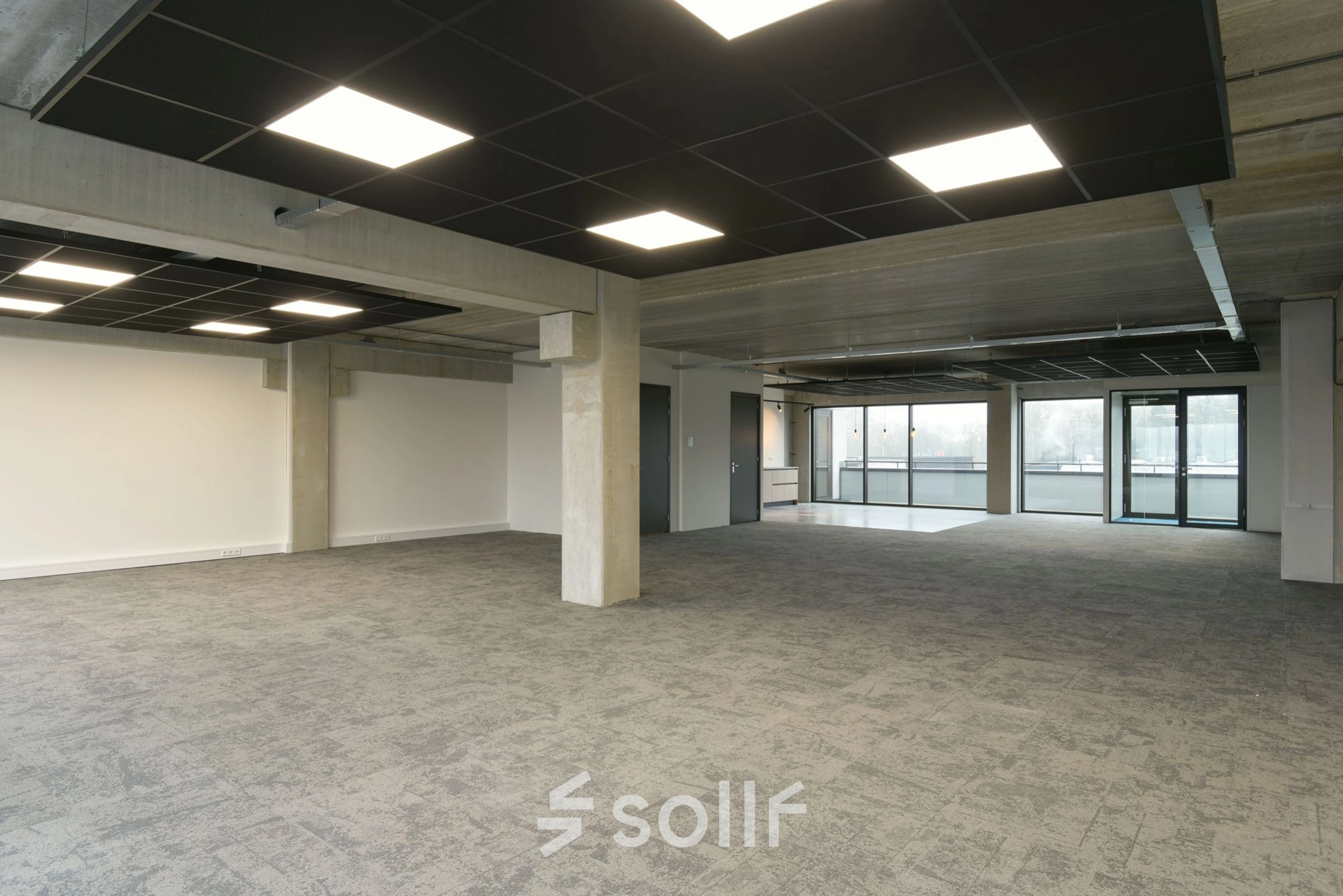 Spacious office to rent at Zuiderloswal 55, Hilversum, featuring large windows and modern lighting, ideal for office space rental.
