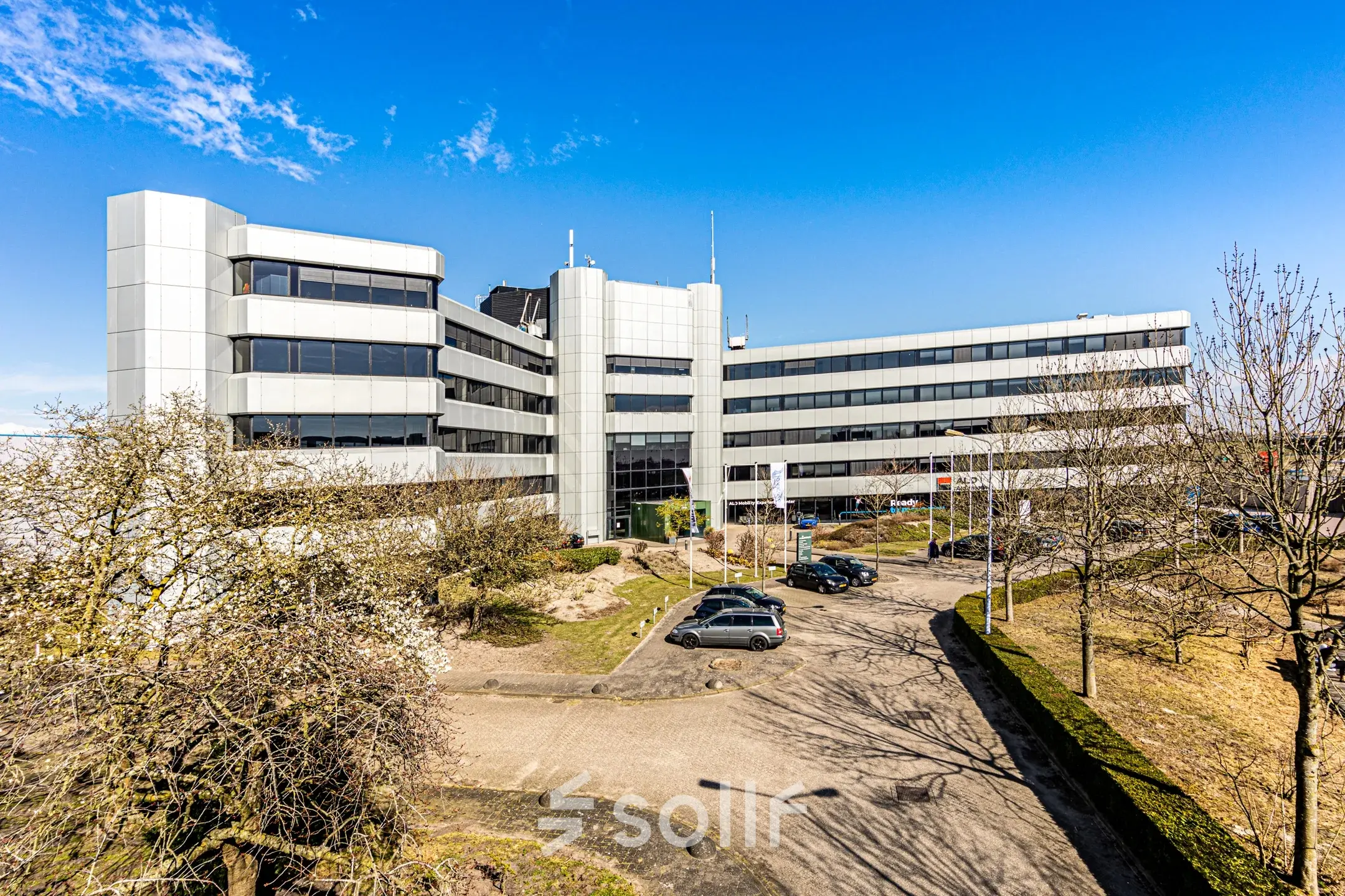 Modern office building at Hoeksteen 54-72, Hoofddorp, ideal for office space rental with ample parking and a sleek exterior.