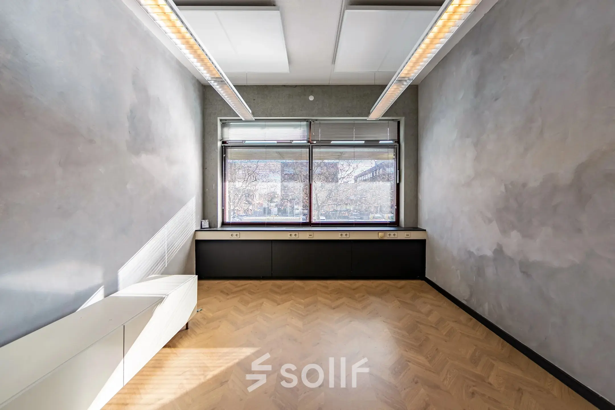 Unfurnished office space rental at Opaallaan 1180, Hoofddorp, featuring large windows and wooden flooring, ideal for a fresh start.