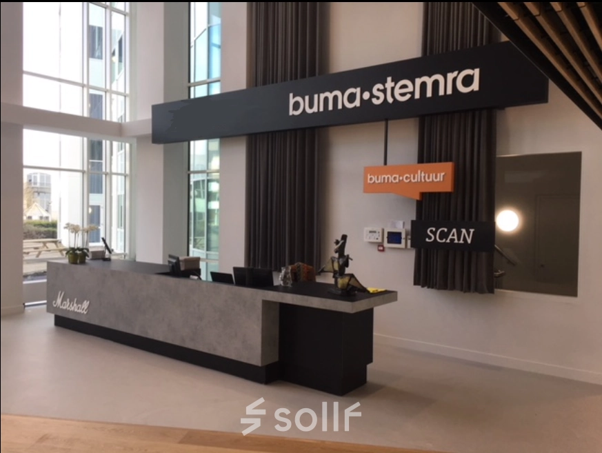Reception area at Saturnusstraat 40-62 in Hoofddorp, featuring a modern counter and signage. Ideal for those looking to rent office space in a contemporary setting.