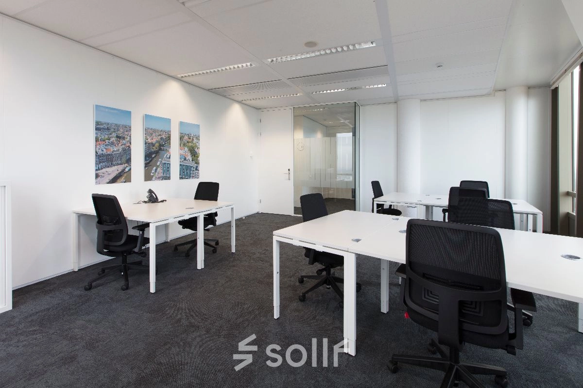 Bright, modern office featuring multiple workstations and minimalistic design at Saturnusstraat 40-62, Hoofddorp. Ideal for office space rental, offering ample natural light and sleek furnishings.