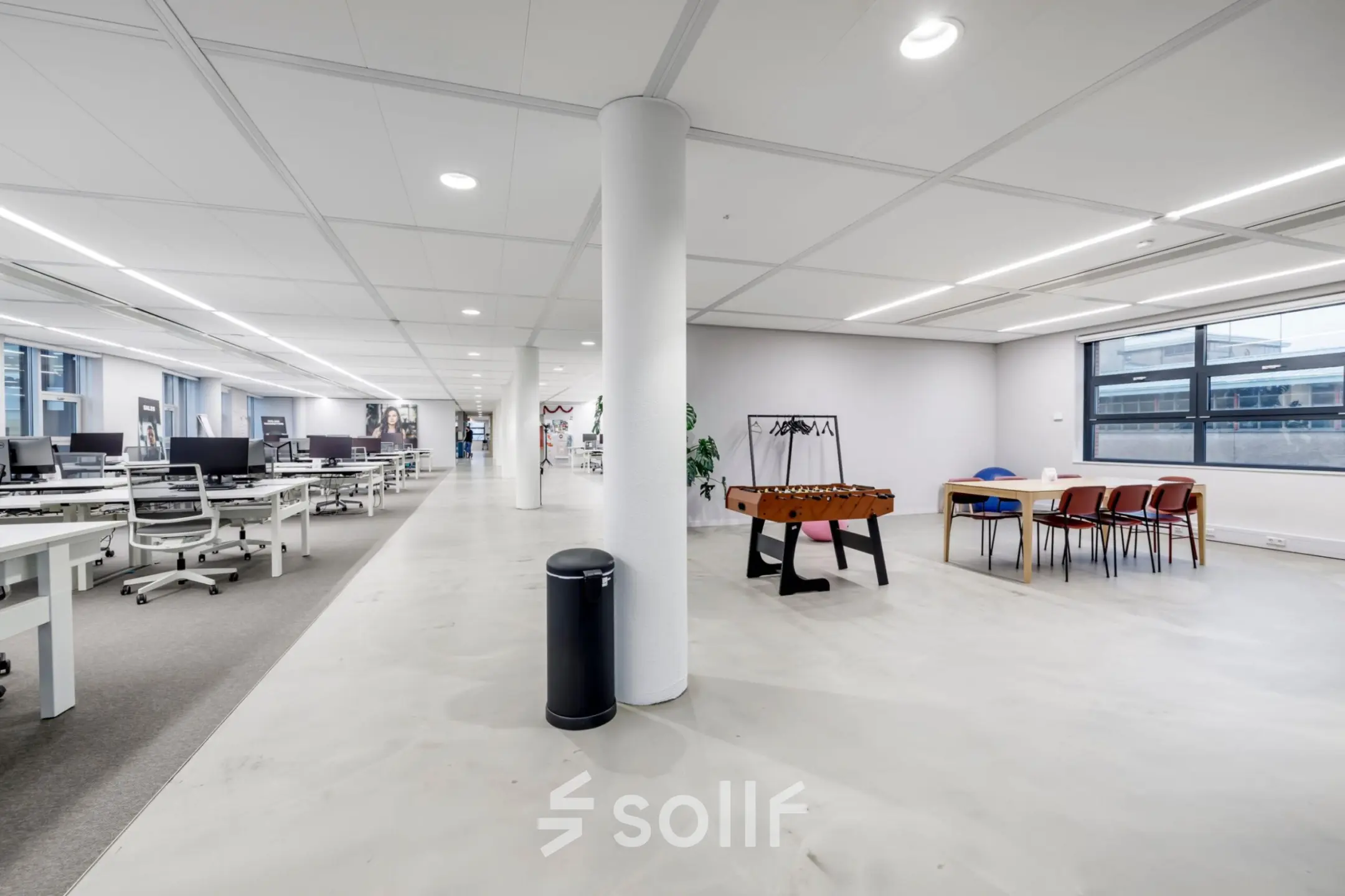 Spacious and modern office to rent in Hoofddorp at Siriusdreef 16, featuring an open floor plan with desks, chairs, and a foosball table, ideal for collaborative workspaces.