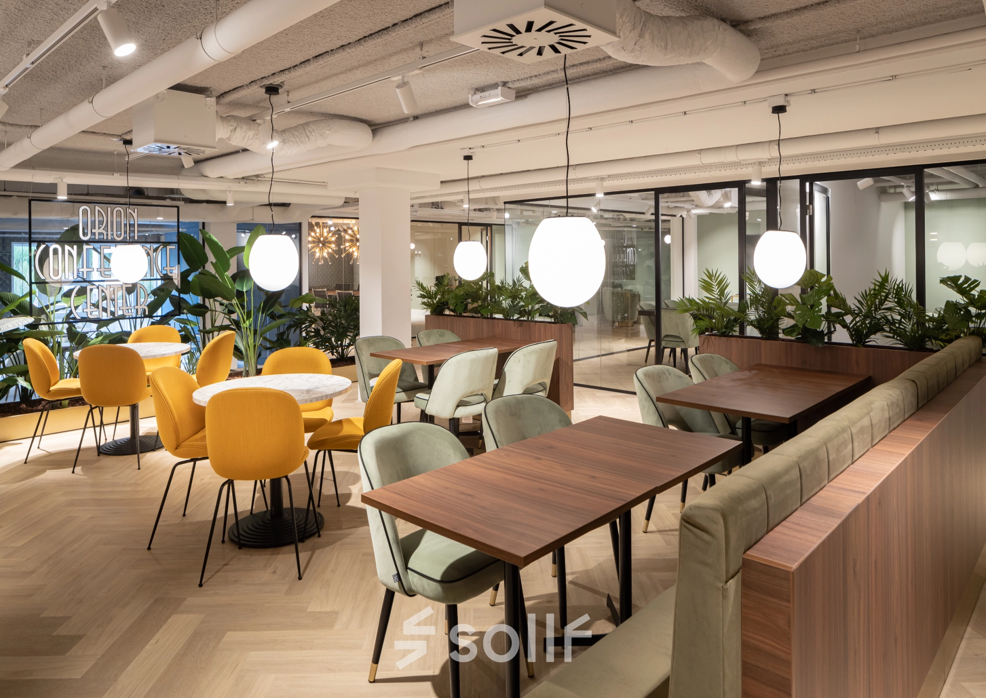 Modern office space with stylish seating and plants at Siriusdreef 60, ideal for collaborative work and inviting for office space rental.
