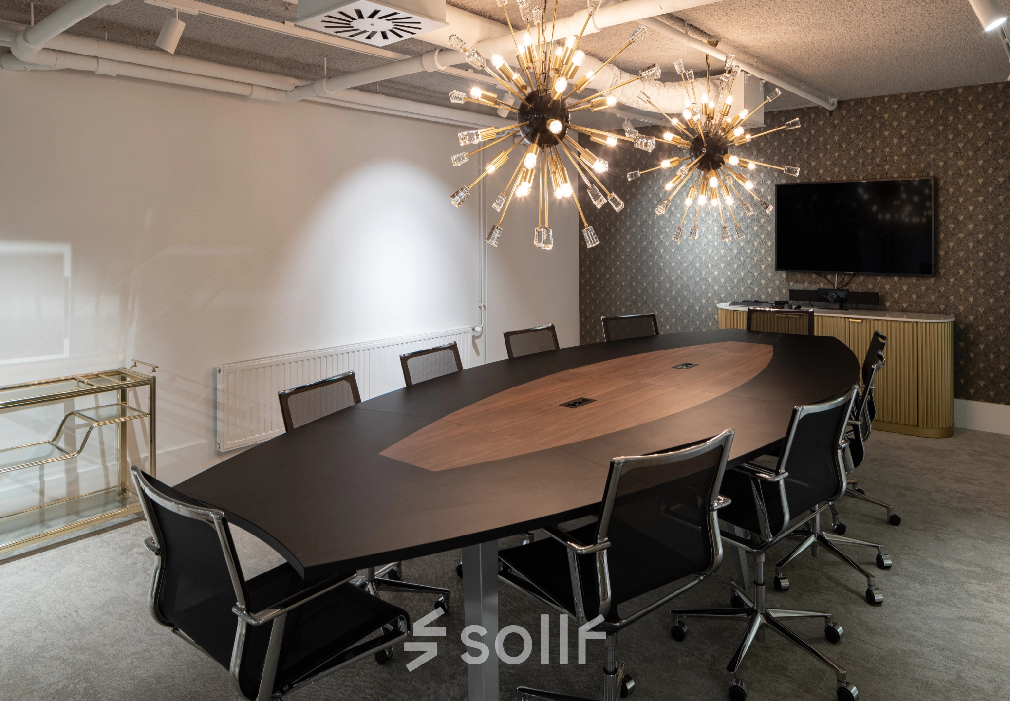 Modern conference room at Siriusdreef 60, Hoofddorp, featuring a stylish oval table, sleek chairs, and unique lighting fixtures. Ideal for office space rental, this setup encourages professional collaboration.