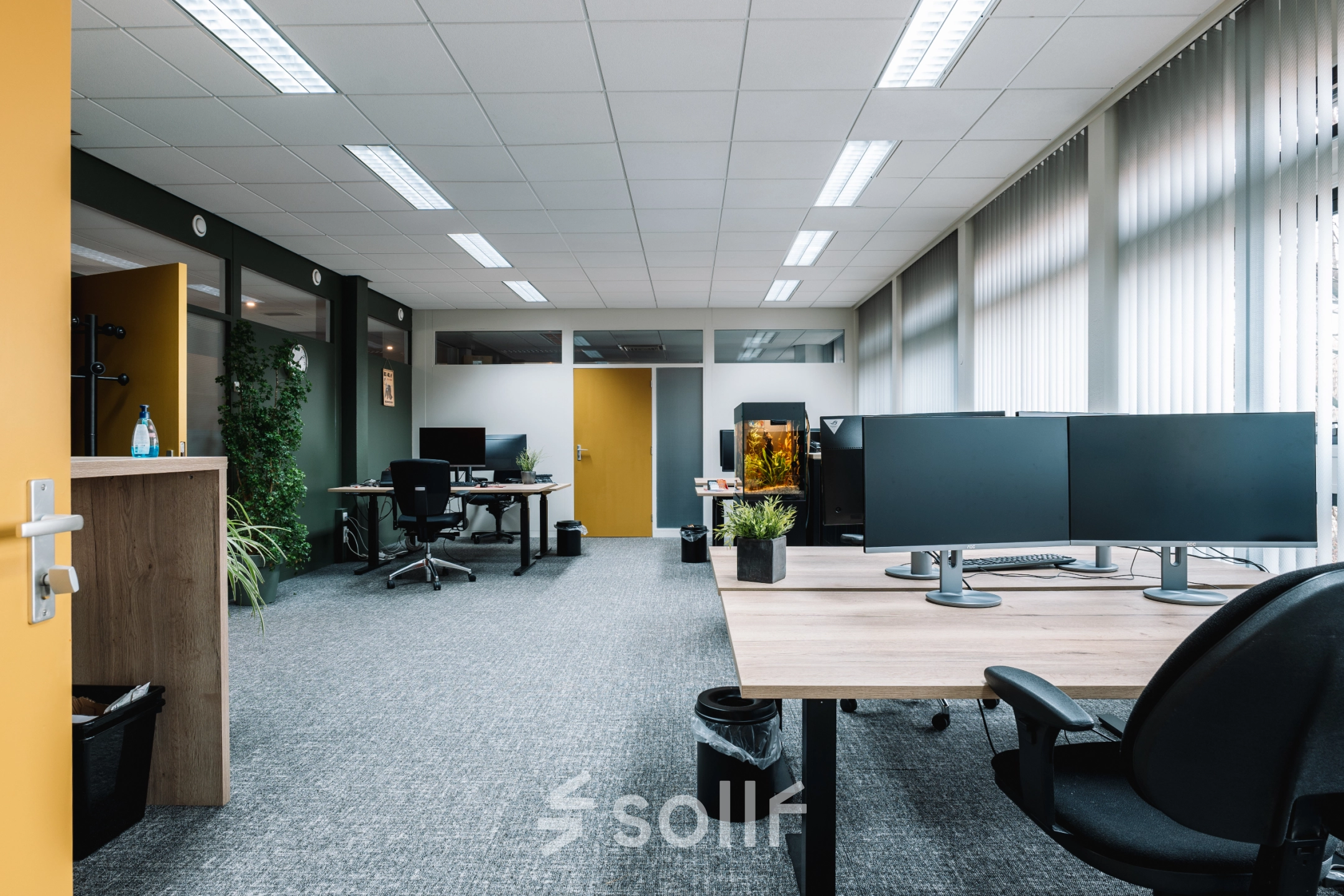 Spacious, furnished office to rent at De Vos van Steenwijklaan 75 in Hoogeveen, featuring modern workspaces and computer stations ready for office space rental.