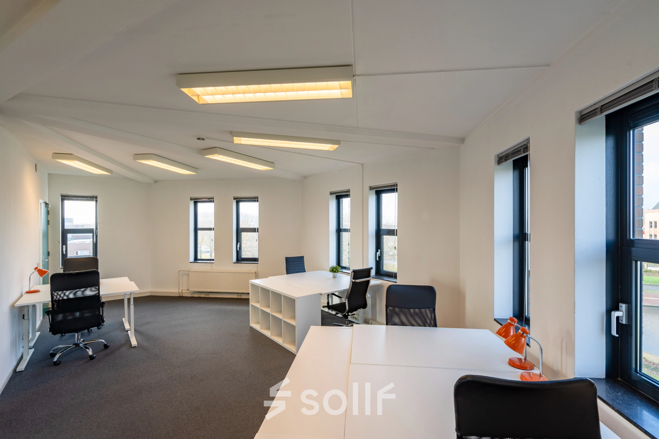 Bright office space with large windows and modern furnishings at Hoofdveste 2, Houten, ideal for office space rental.