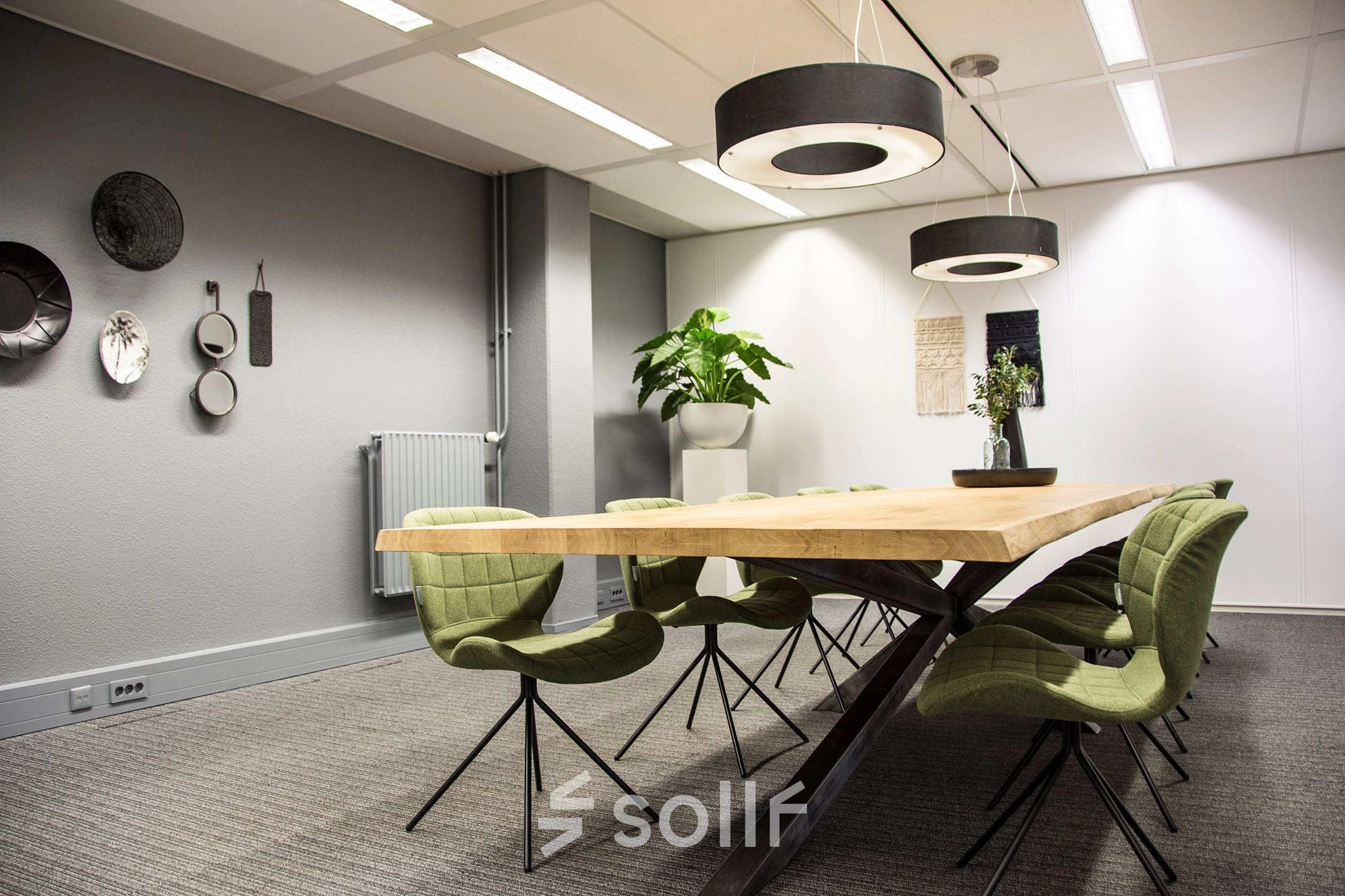 Spacious, well-lit office meeting room with wooden table and modern chairs at Meidoornkade 22, perfect for office space rental.