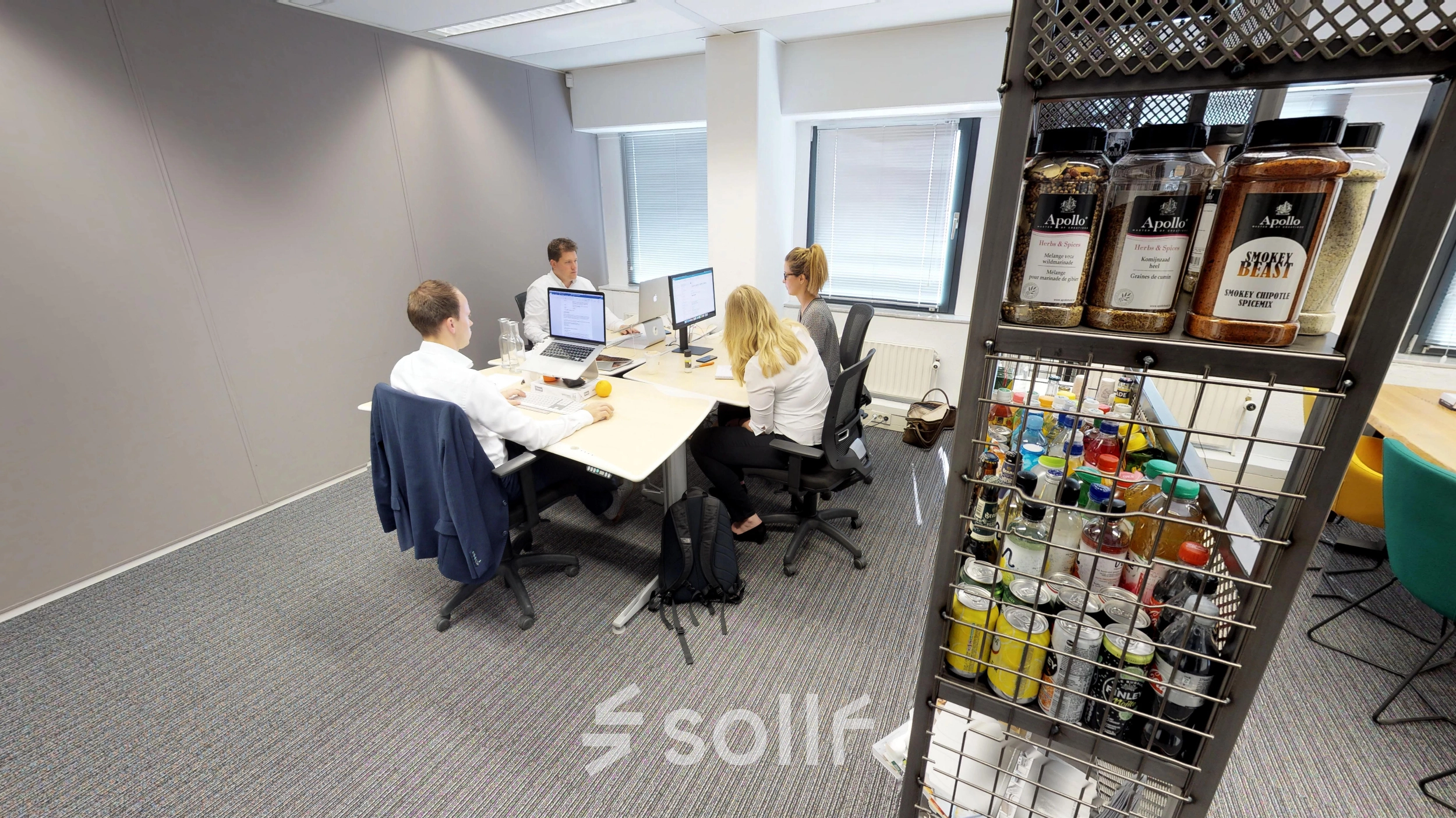 Professionals collaborate at desks in a furnished office space at Meidoornkade 22, Houten, highlighting a practical office to rent with ample workspace facilities.