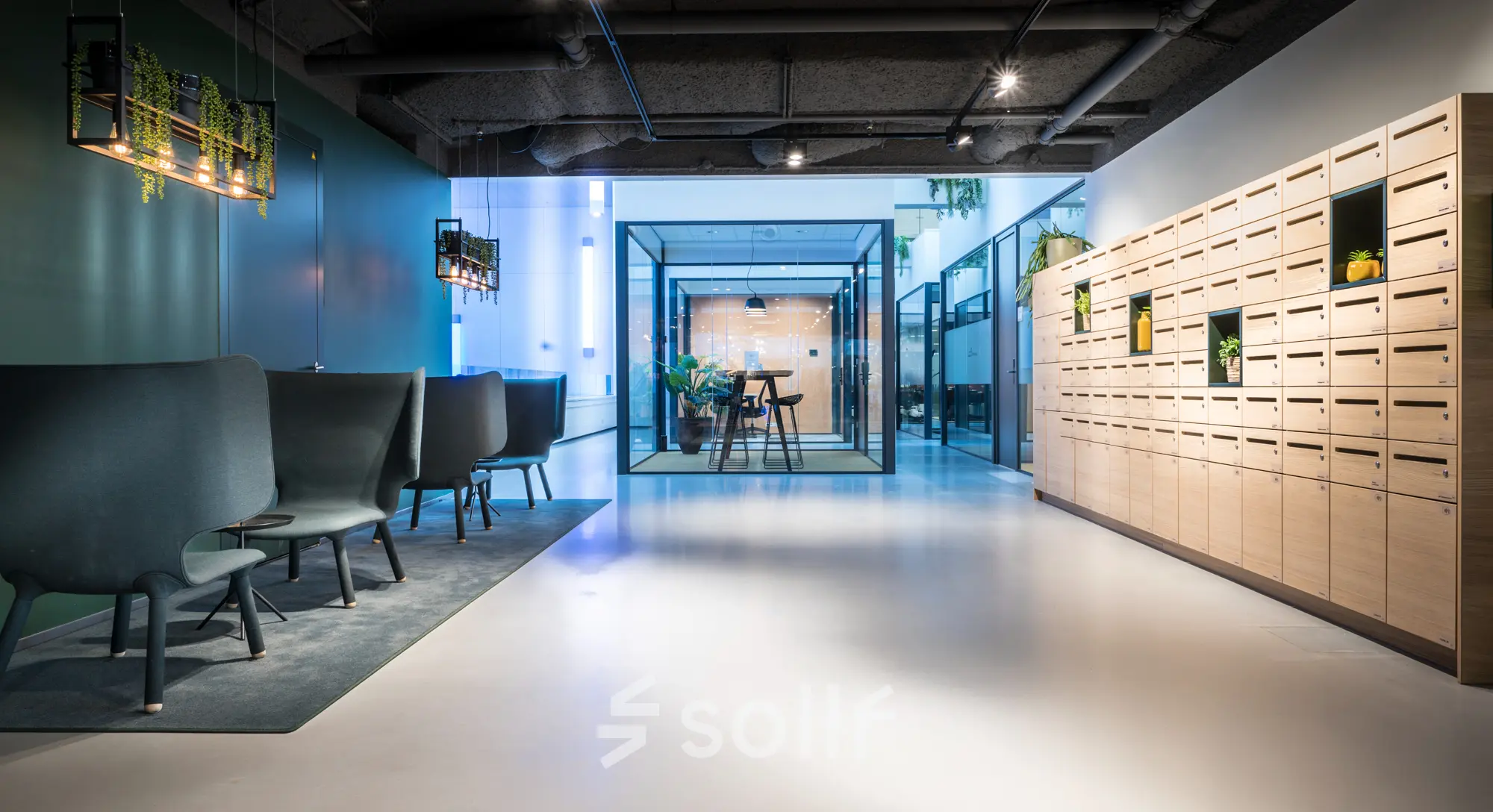 Modern office space to rent in Leiden at Bargelaan 200, featuring sleek seating and a glass meeting room.