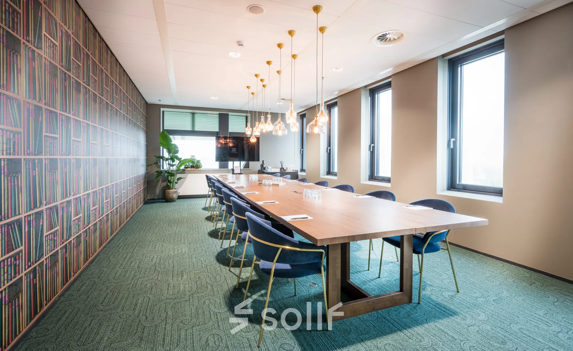 Modern conference room at Bargelaan 200, Leiden, showcasing a long table with elegant chairs, ideal for office space rental. Large windows provide natural light.