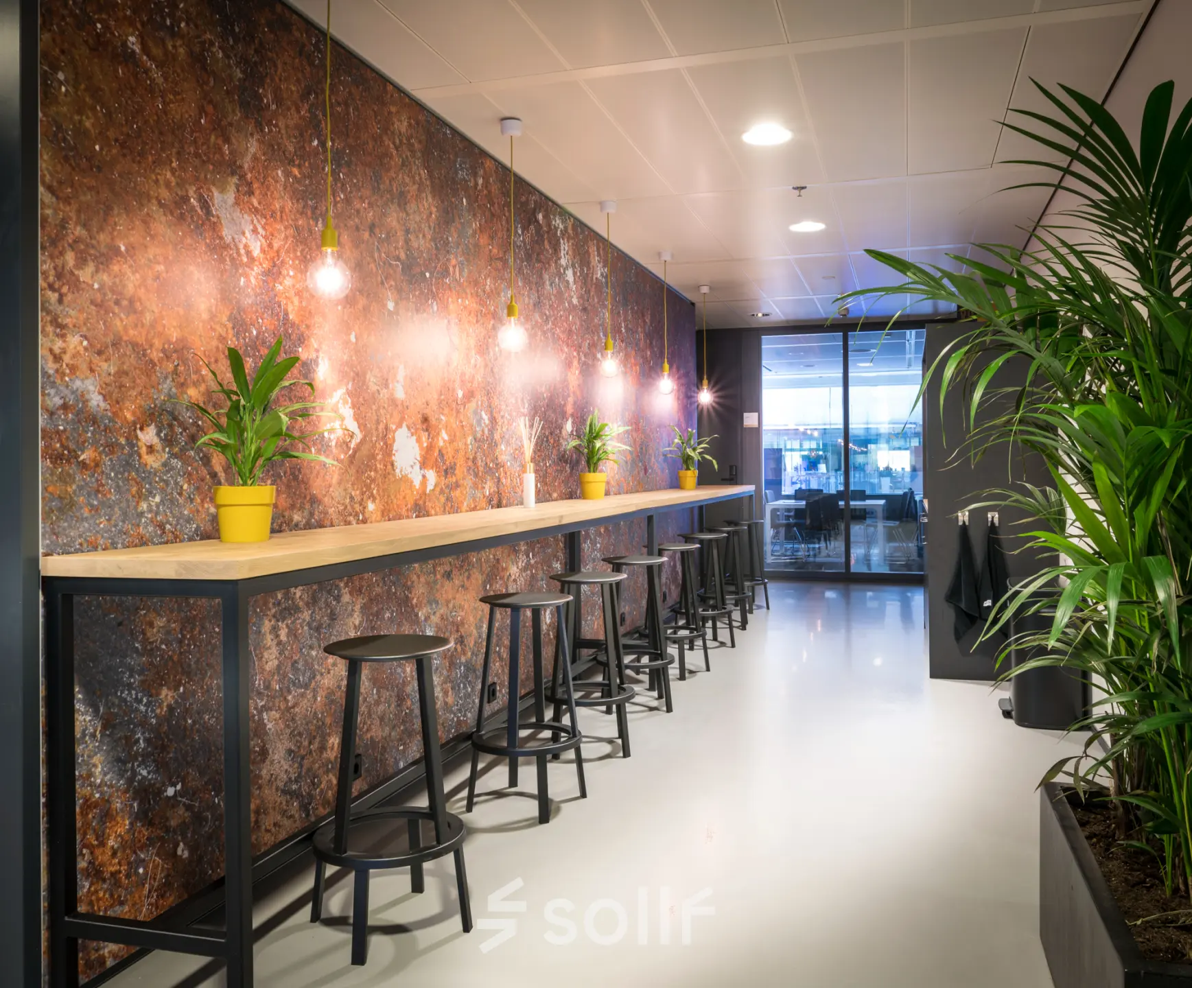Stylish office space with high counter seating and vibrant wall design at Bargelaan 200, Leiden, ideal for office space rental.