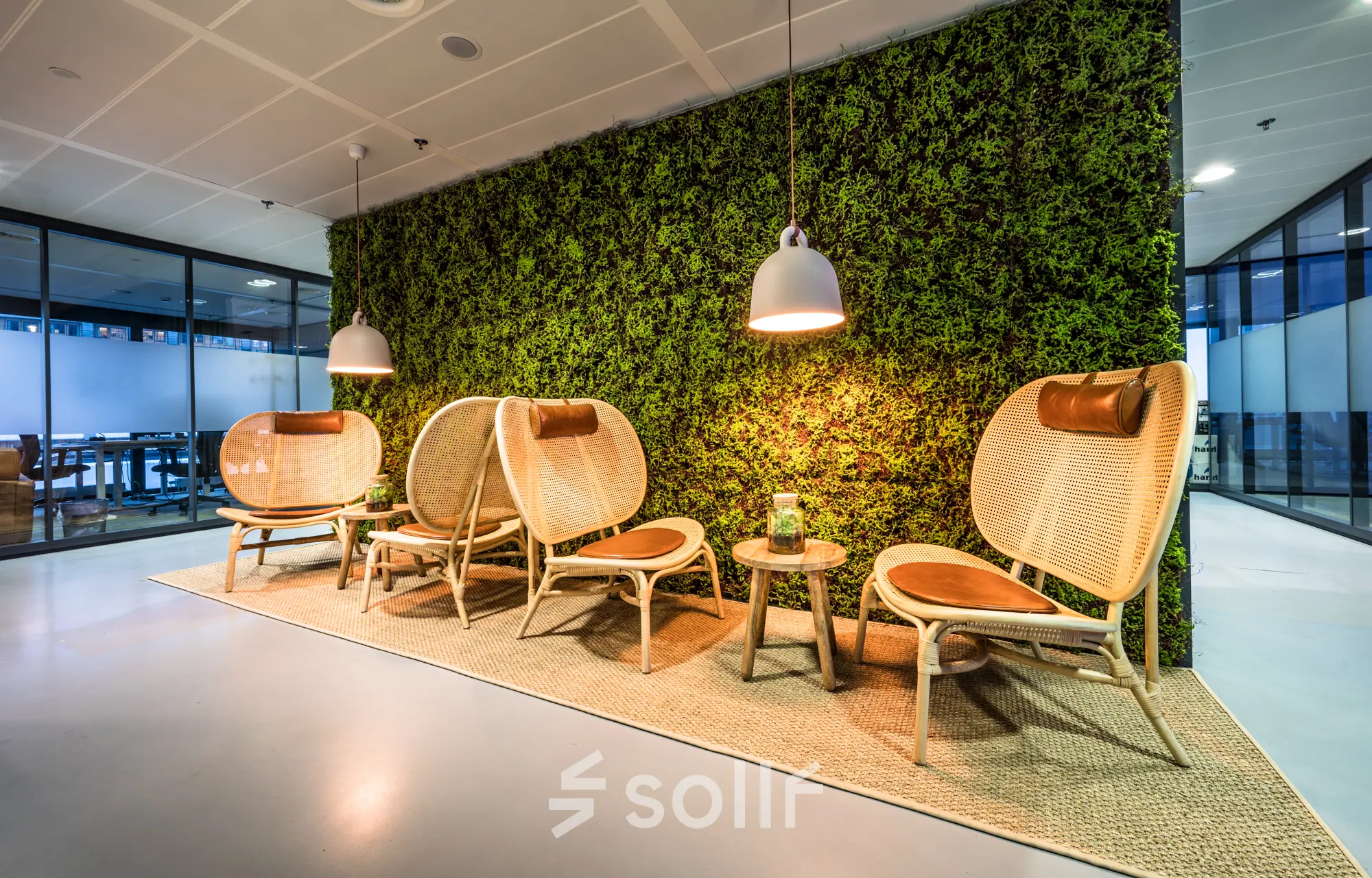Modern office area at Bargelaan 200, Leiden, featuring stylish seating against a lush green wall, ideal for rent office space seekers.