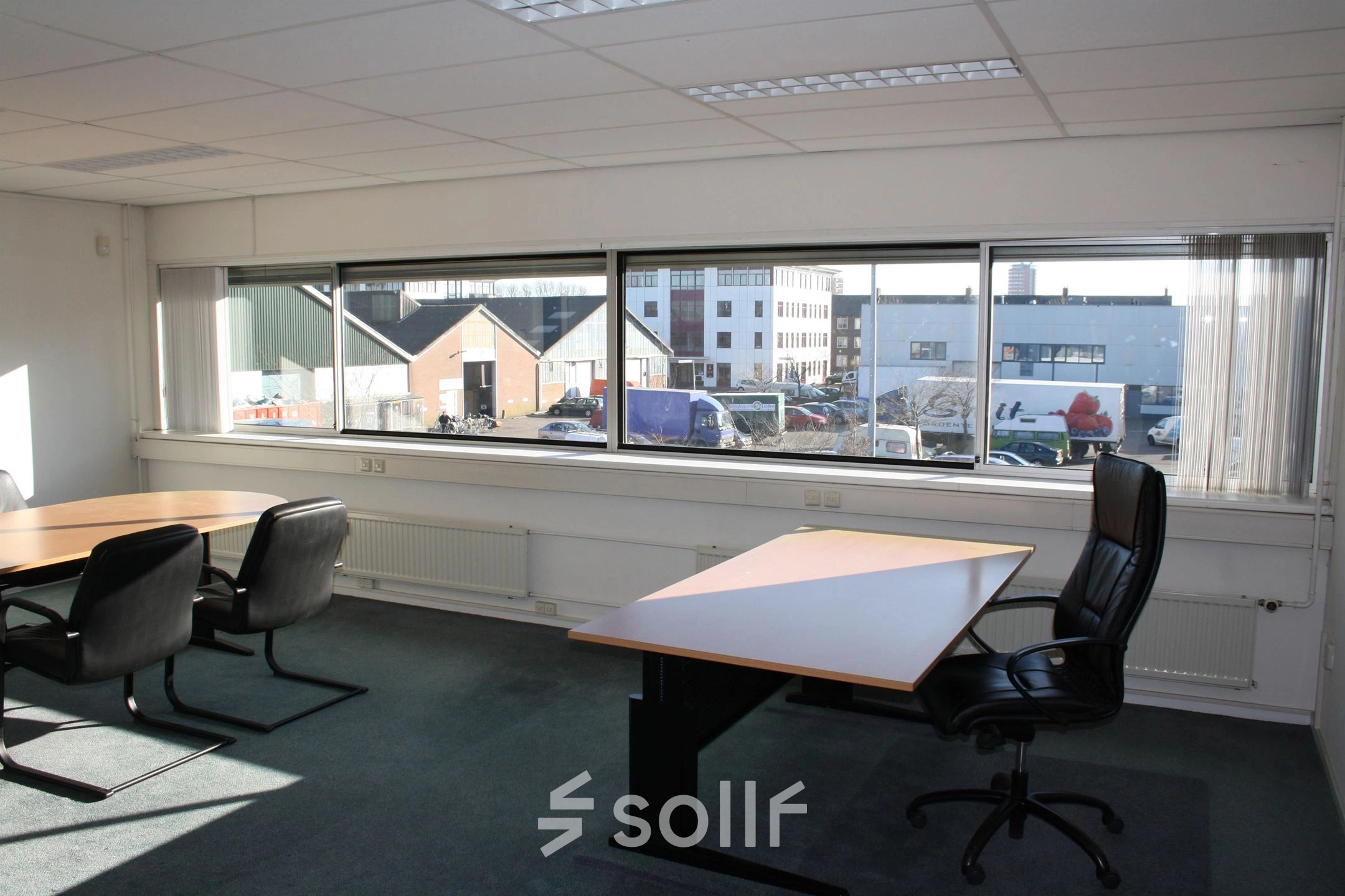 Spacious office to rent at Fruitweg 22, Leiden, featuring large windows and modern furnishings. Ideal for professionals seeking office space rental with ample natural light.