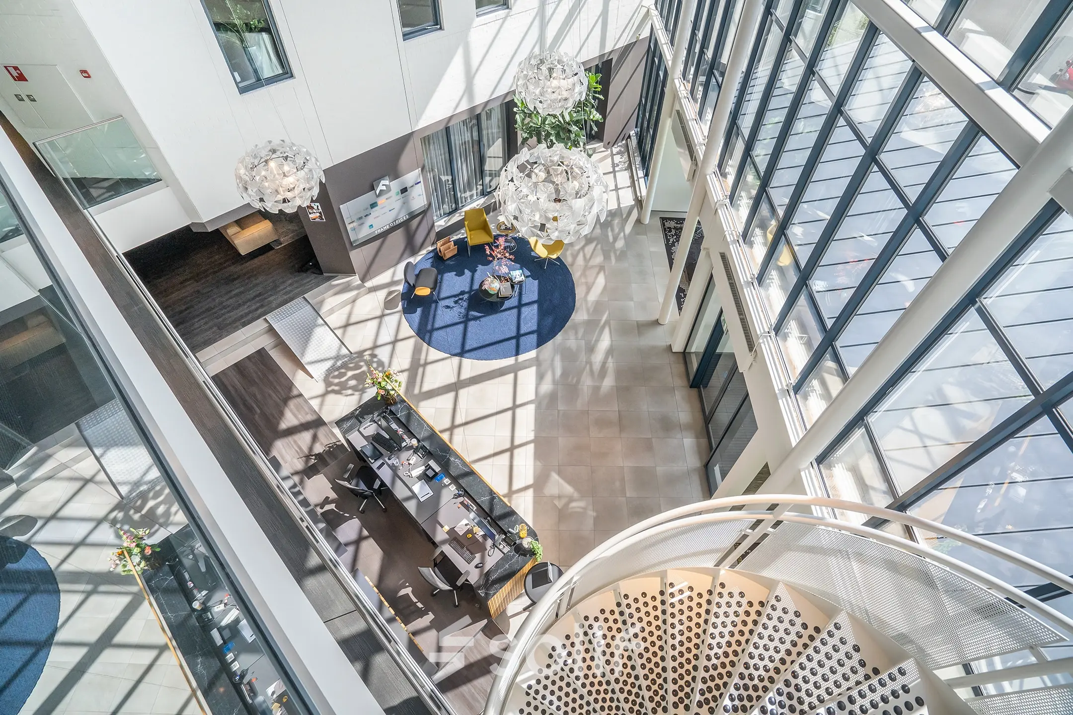 A modern office space at Kanaalpark 140 in Leiden featuring a spacious reception area with contemporary seating, plants, and decorative lighting. Ideal for office space rental.