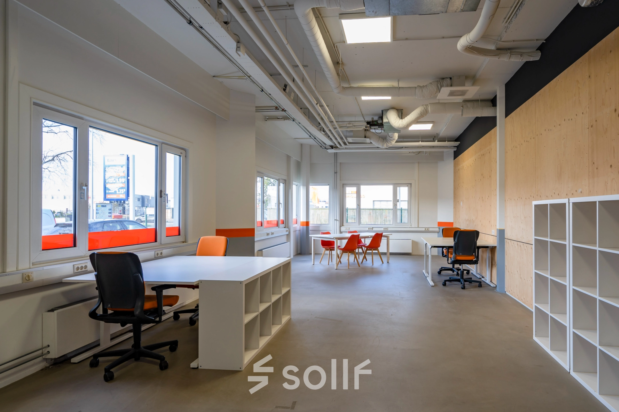 Interior view of an office space at Touwbaan 38, Leiderdorp, featuring modern workspaces with desks and chairs bathed in natural light through large windows; ideal for office space rental.